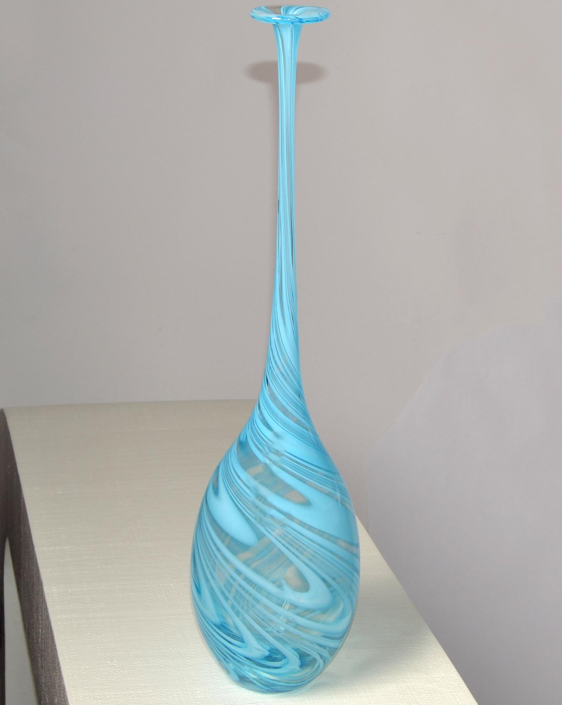 Tall Mid-Century Modern Italian blown Murano Bud Vase in baby blue swirl design attributed to Vetro Artistico.
The Vessel has a very long neck and a Teardrop style core. The Top opening looks like a Flower Blossom.
The Size is for a long single