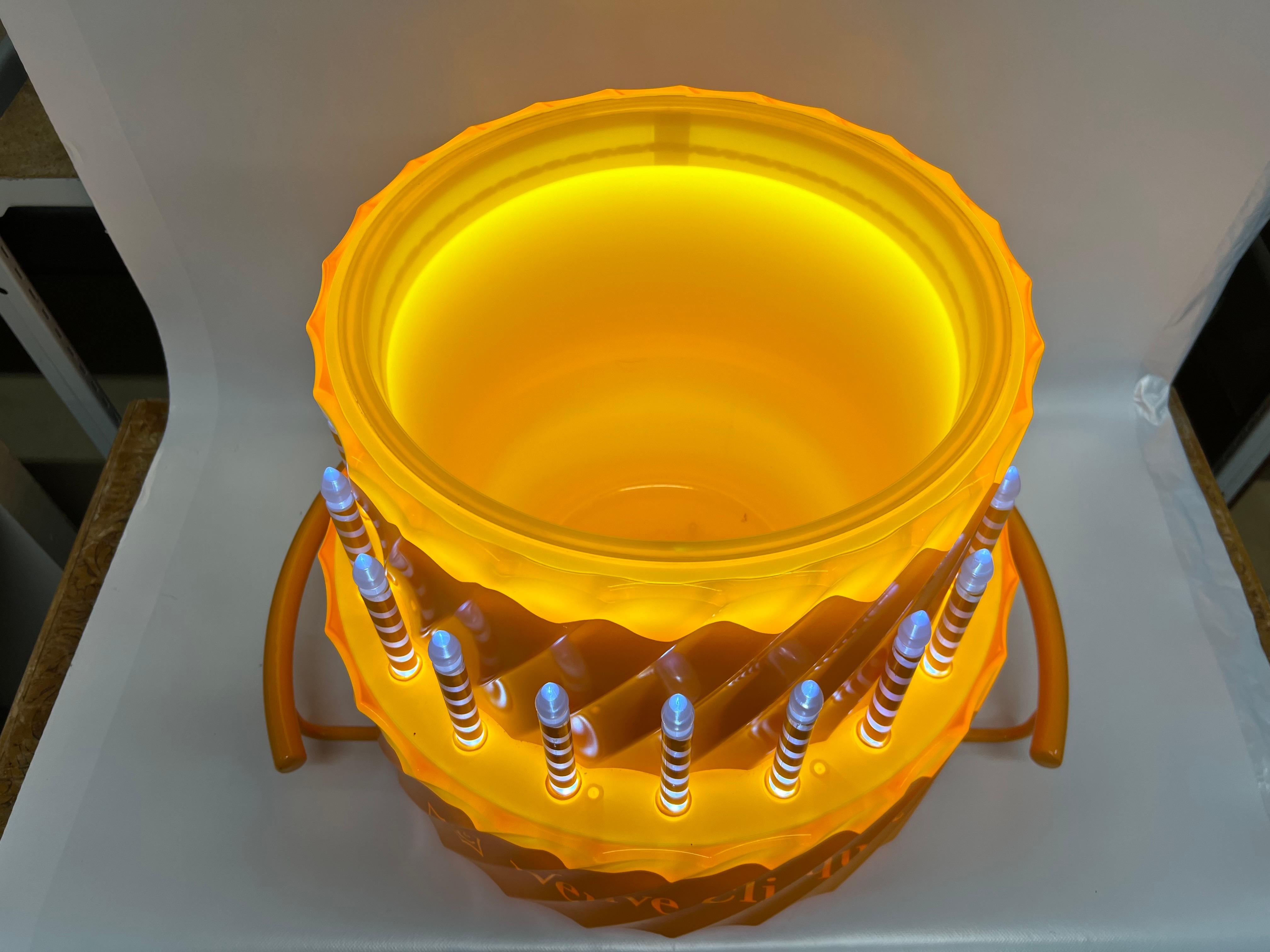 From the creators of this special limited edition price, Bish,” The objective for the Veuve Clicquot Celebratory Cake Bottle Presenter was to design a vehicle to deliver a celebratory experience to the consumer at an on-premise establishment that