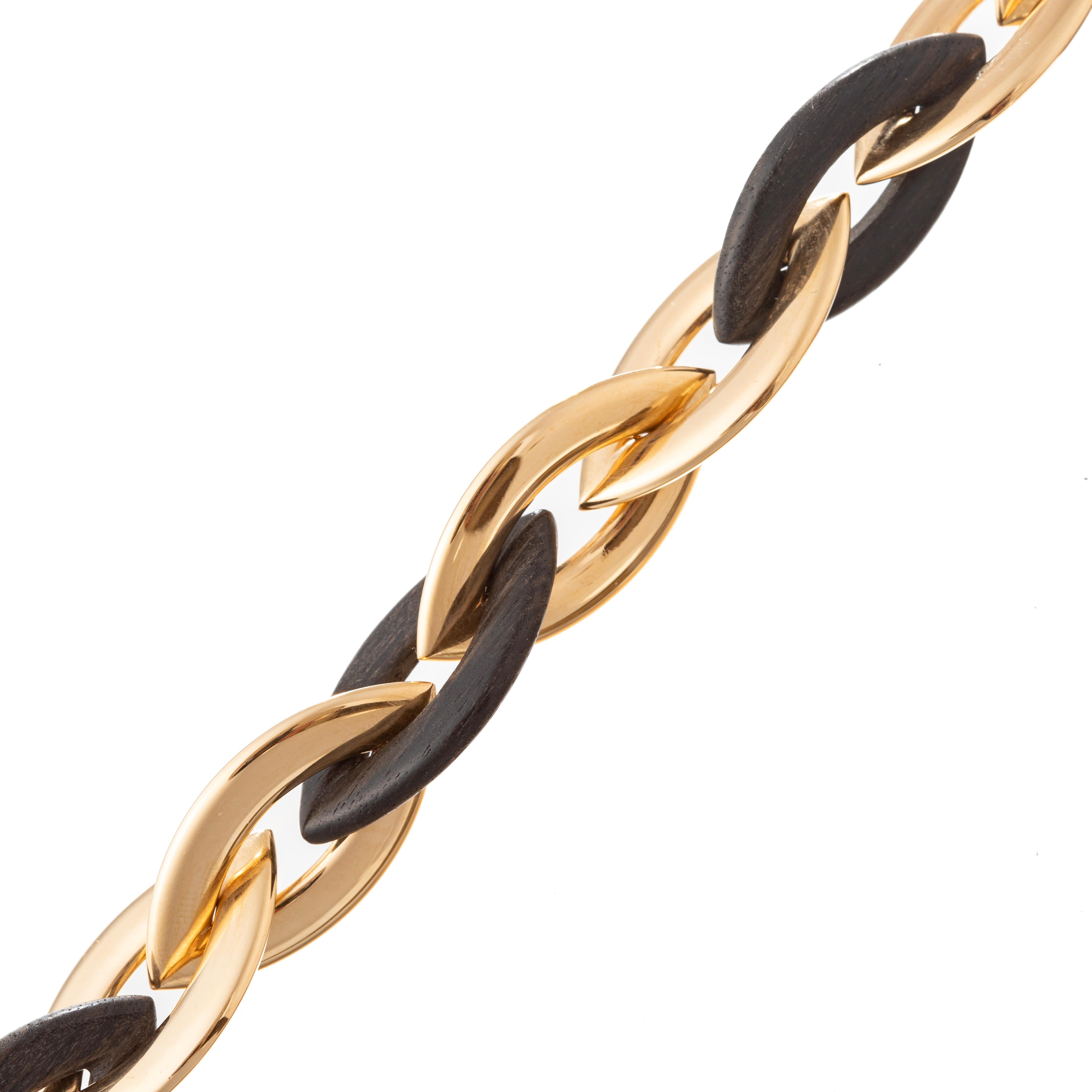 Vhernier Doppio Senso bracelet, featuring four marquise-shaped carved ebony wood links and eight 18k rose gold polished links.  One link opens as a clasp.  Signed 