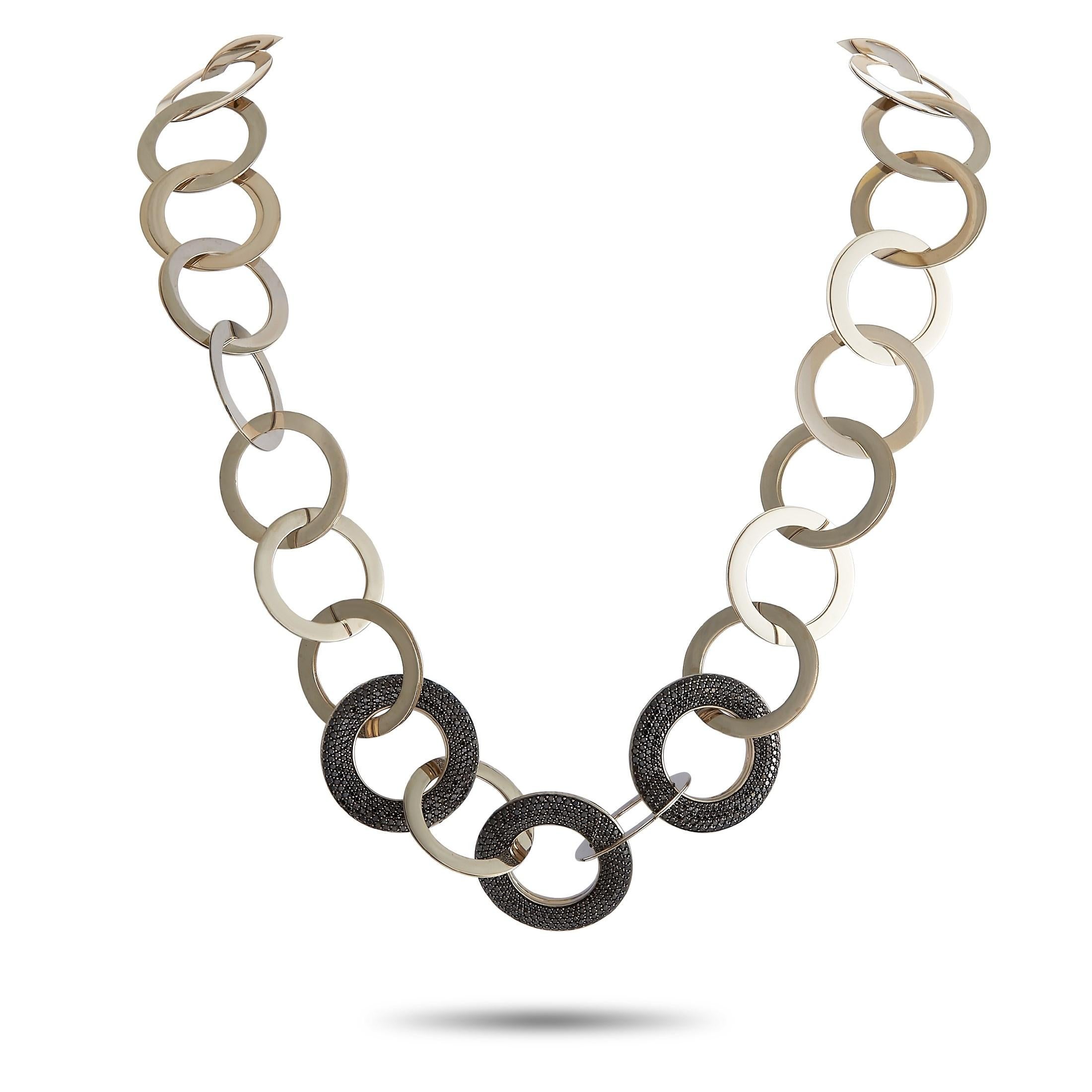 There’s more to this Vhernier necklace than first meets the eye. A series of round 18K yellow gold links come together to create this stunning design, which measures 26” long. A trio of rings also include 7.50 carats of white diamonds on one side