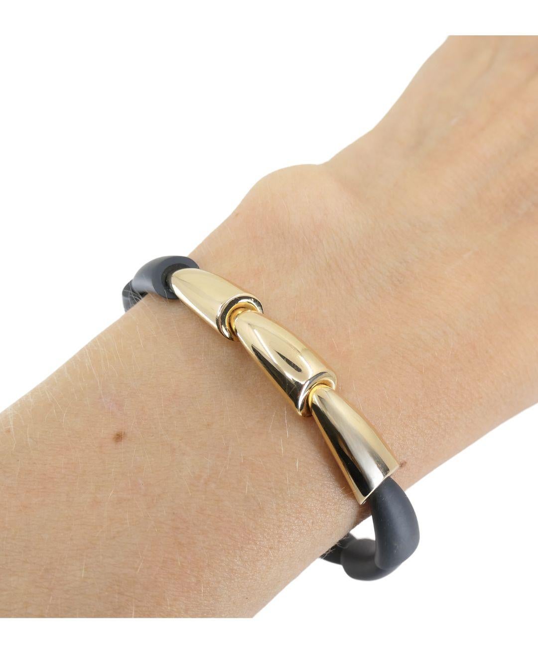 A beautiful Vhernier bracelet from the Calla collection, crafted from titanium and 18k yellow gold.
The bracelet comprises titanium cones nested in each other, with three gold cones set in the center. A soft matte finish of titanium creates a