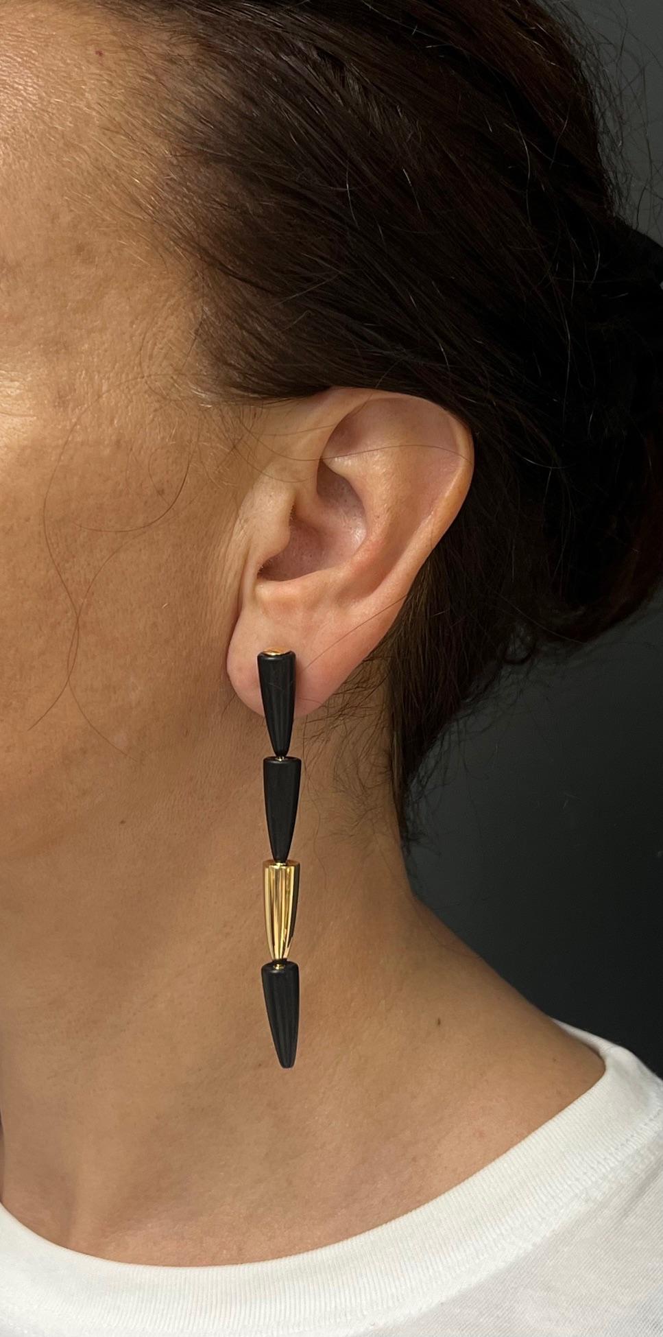 Futuristic earrings by Vhernier, from Calla collection, made in 18k gold and ebony wood. Elongated silhouette earrings consist of four cones vertically nested in each other. One silky polished gold cone alternated with three wood cones. The darkness