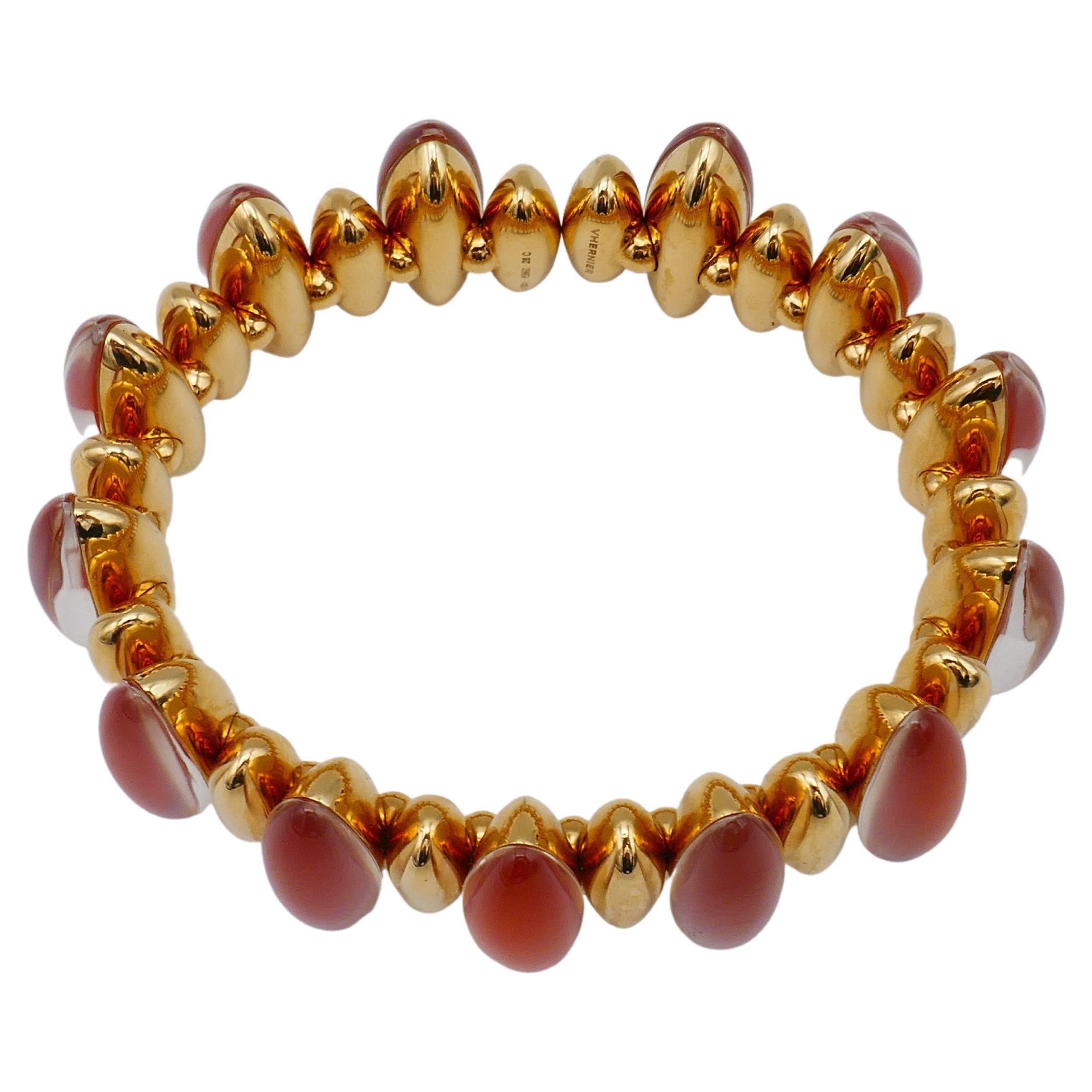 A stunning bracelet by Vhernier from Fuseau collection. Features cabochon cut red carnelian, rock crystal and 18k yellow gold. Stamped with Vhernier maker's mark, a hallmark for 18k gold and a serial number. 
Measurements: the inner circumference is