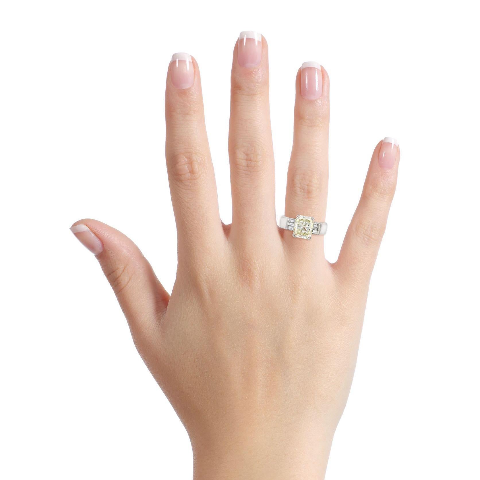 2.53 Carat cushion modified light yellow natural diamond set in a polished platinum setting with 3 baguette cut diamonds on each side. Carved platinum details on edges with filigree. Signed Viachi. 

Size, 6
Height, 7mm
Width, 10 - 5mm
Depth, 2.5mm