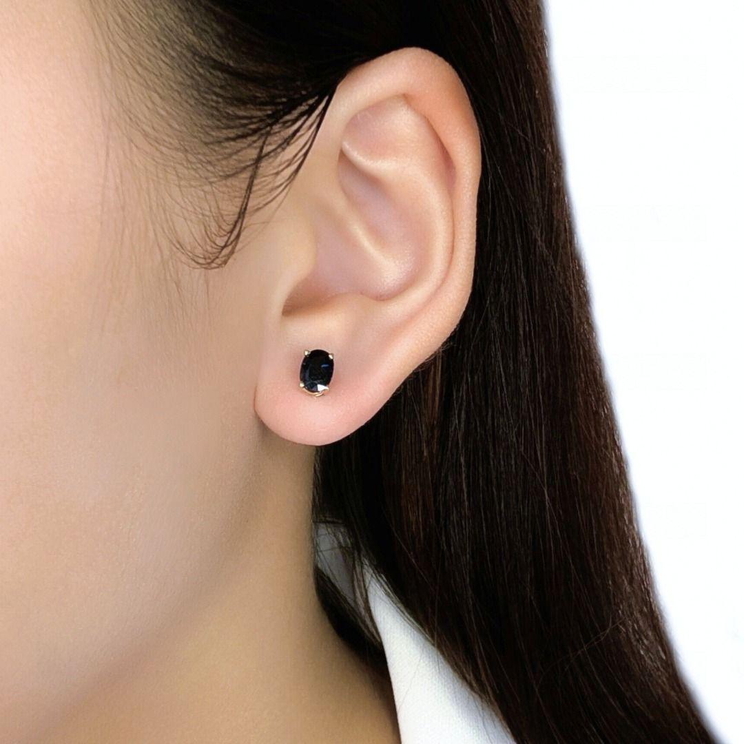 Elevate your style with these vibrant, unworn stud earrings, meticulously crafted in radiant 18K yellow gold. Each earring features a magnificent natural oval-cut sapphire, totaling an impressive 1.62ct for the pair, radiating a rich, dark blue hue