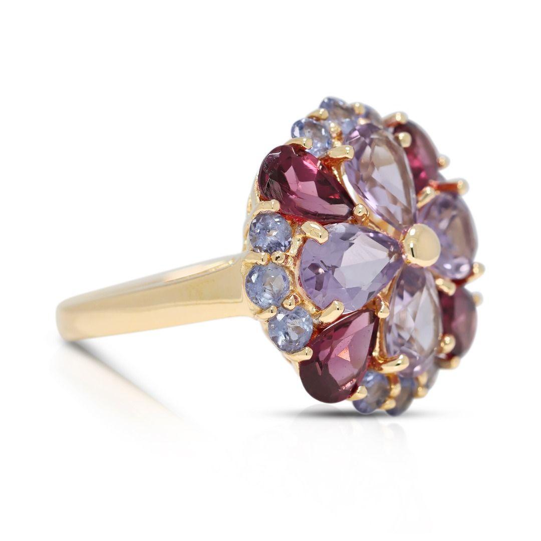 A breathtaking fusion of color and elegance, this 14K yellow gold ring features four pear-shaped amethysts, totaling 1.92 carats, radiating a rich purple hue at its center. Complementing its brilliance are four pear-shaped red tourmalines (0.8ct