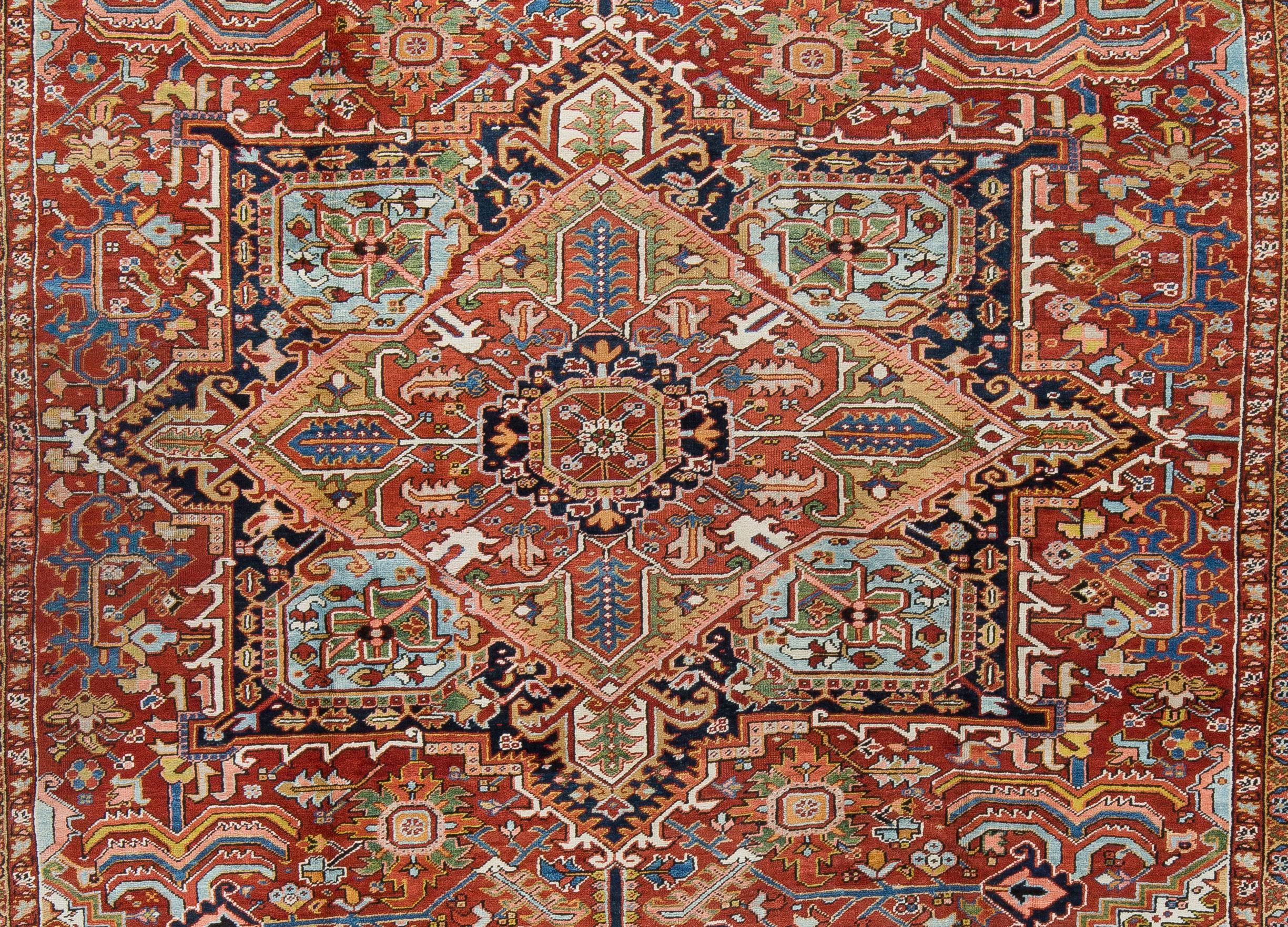 A vibrant high quality Heriz rug from Northwest Iran. This tribal rug from the mountains boasts a soft wool and strong foundation making it suitable for high traffic locations. An array of colors anchored with bright ivory corner pockets.Naturally