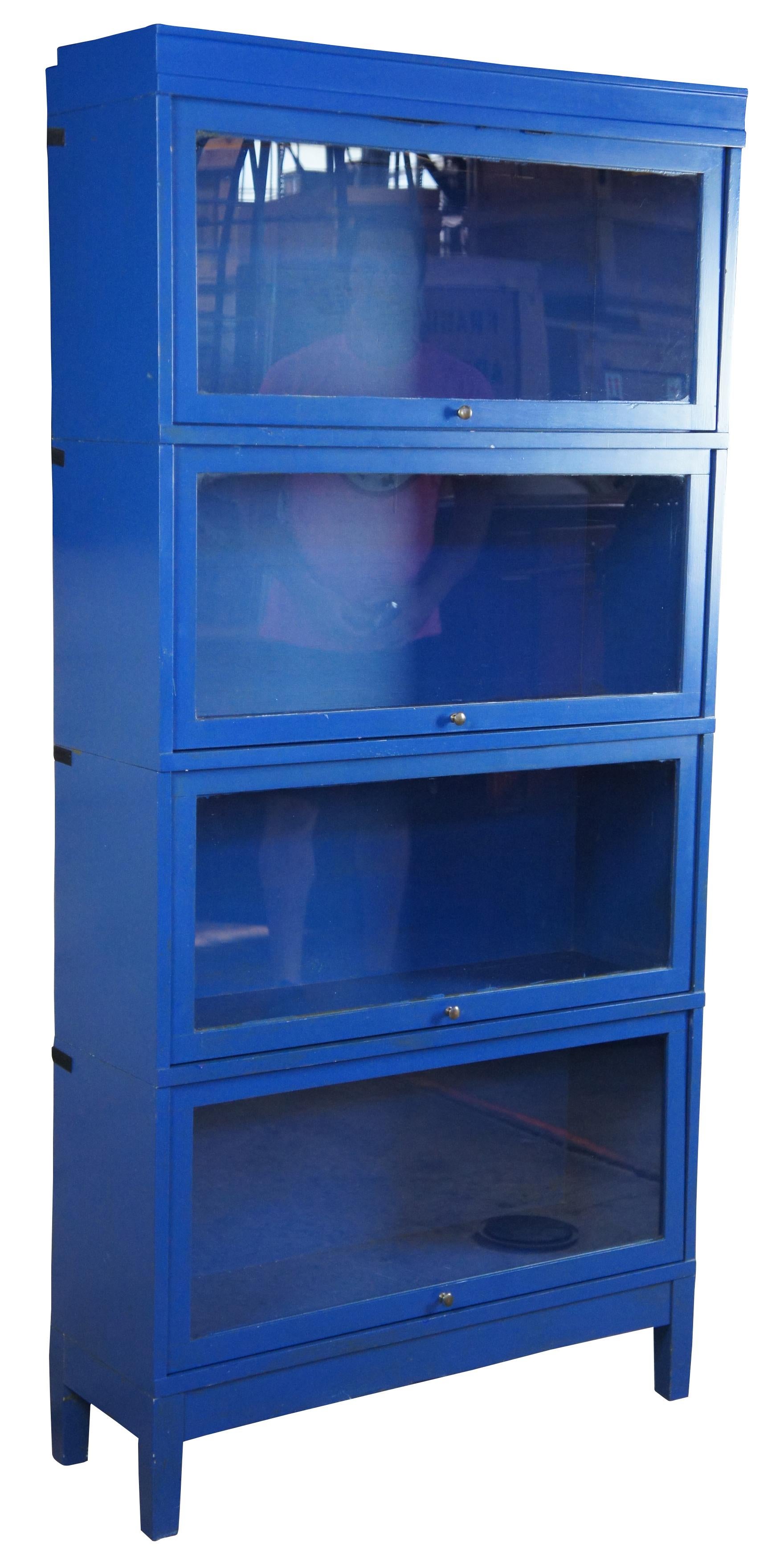 Modern painted blue library barrister bookcase. Features modular sections that stack. Made of wood and glass. Measure: 71