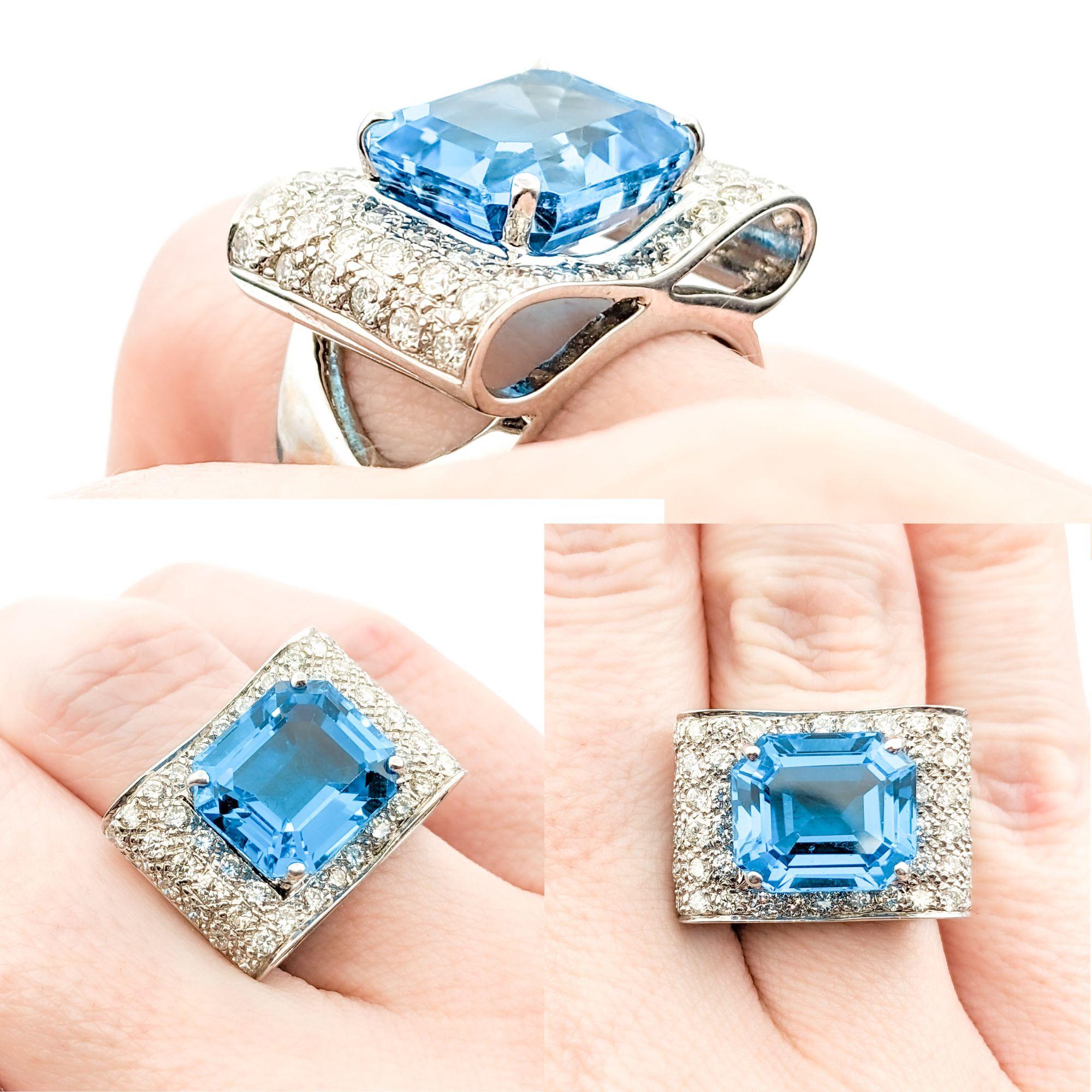 Vibrant Blue Topaz & Diamond Statement Ring

Crafted from 14kt white gold, this stunning ring features a prominent 12.50 x 11mm emerald-cut Swiss blue topaz, elegantly framed by .50ctw of round brilliant-cut diamonds. The diamonds, known for their