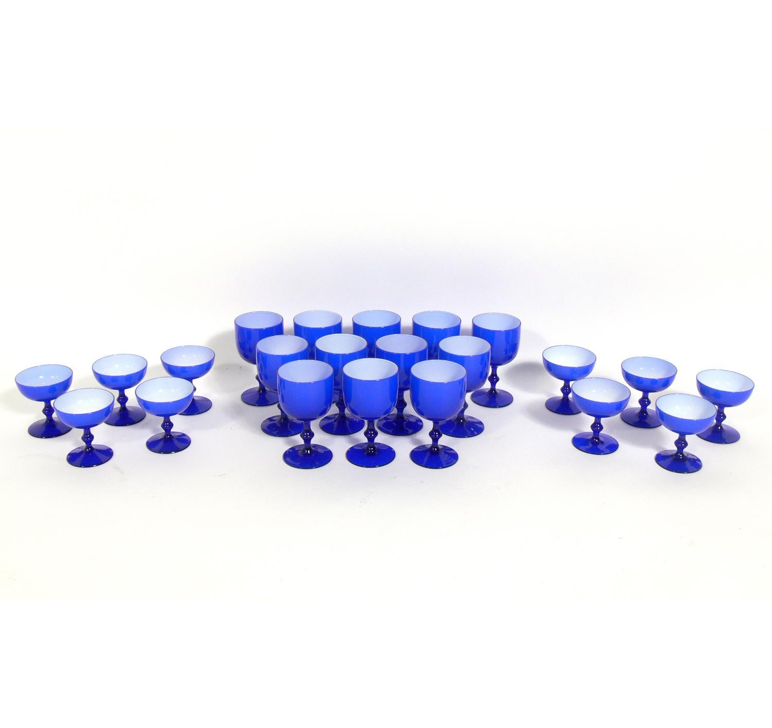 Vibrant set of cobalt blue glasses, designed by Carlo Moretti for Empoli, Italy, circa 1950s. The set consists of 22 glasses, 12 larger glasses measuring 5.75