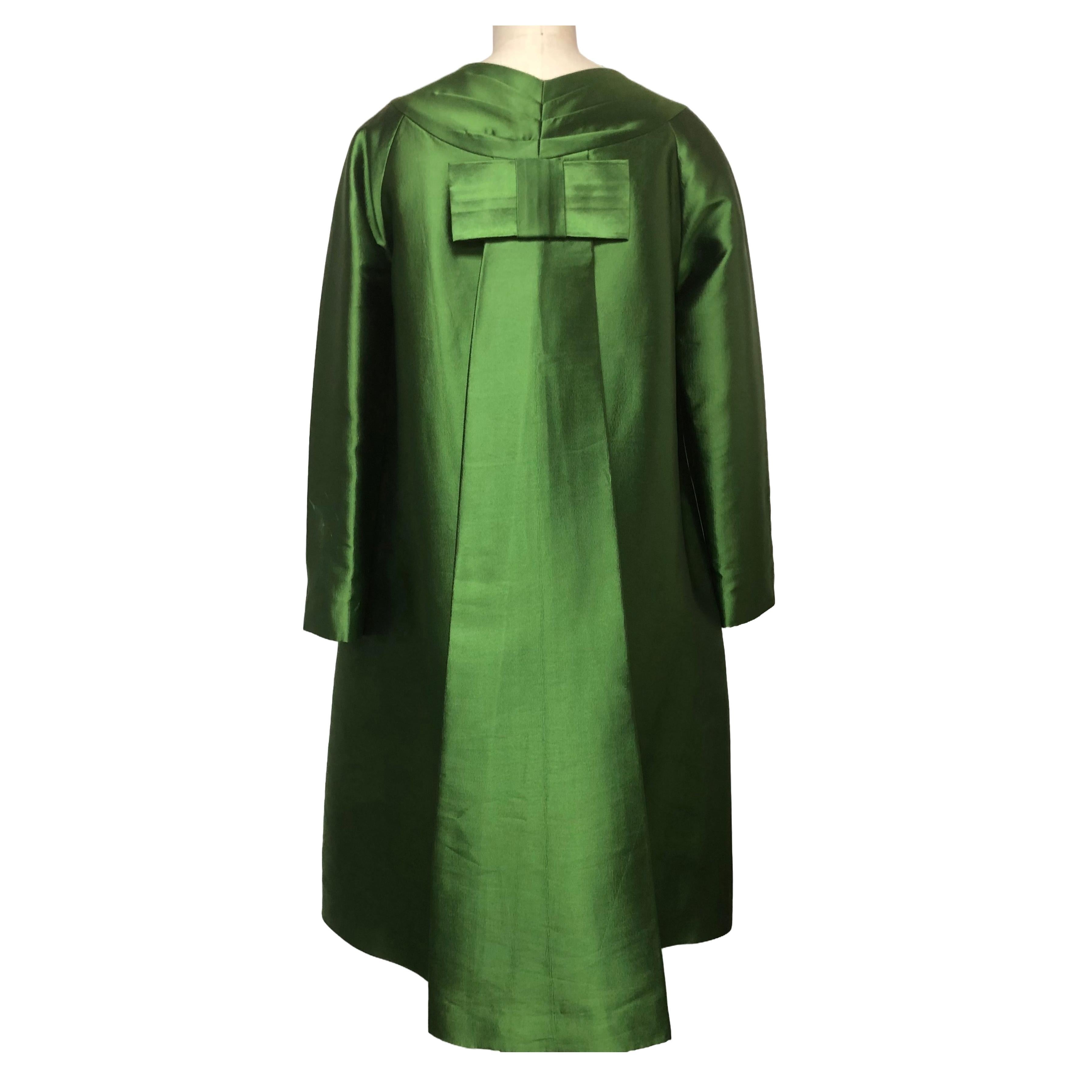 A charming Opera Coat of 100% French  Emerald Silk Mikado from Sfate and Combier- maker of the finest Couture Textiles. The Pleat Back is Secured with a  Bow. A Roomy Coat  that comfortably fits over Dresses etc.
A wink and a nod to the glamour of