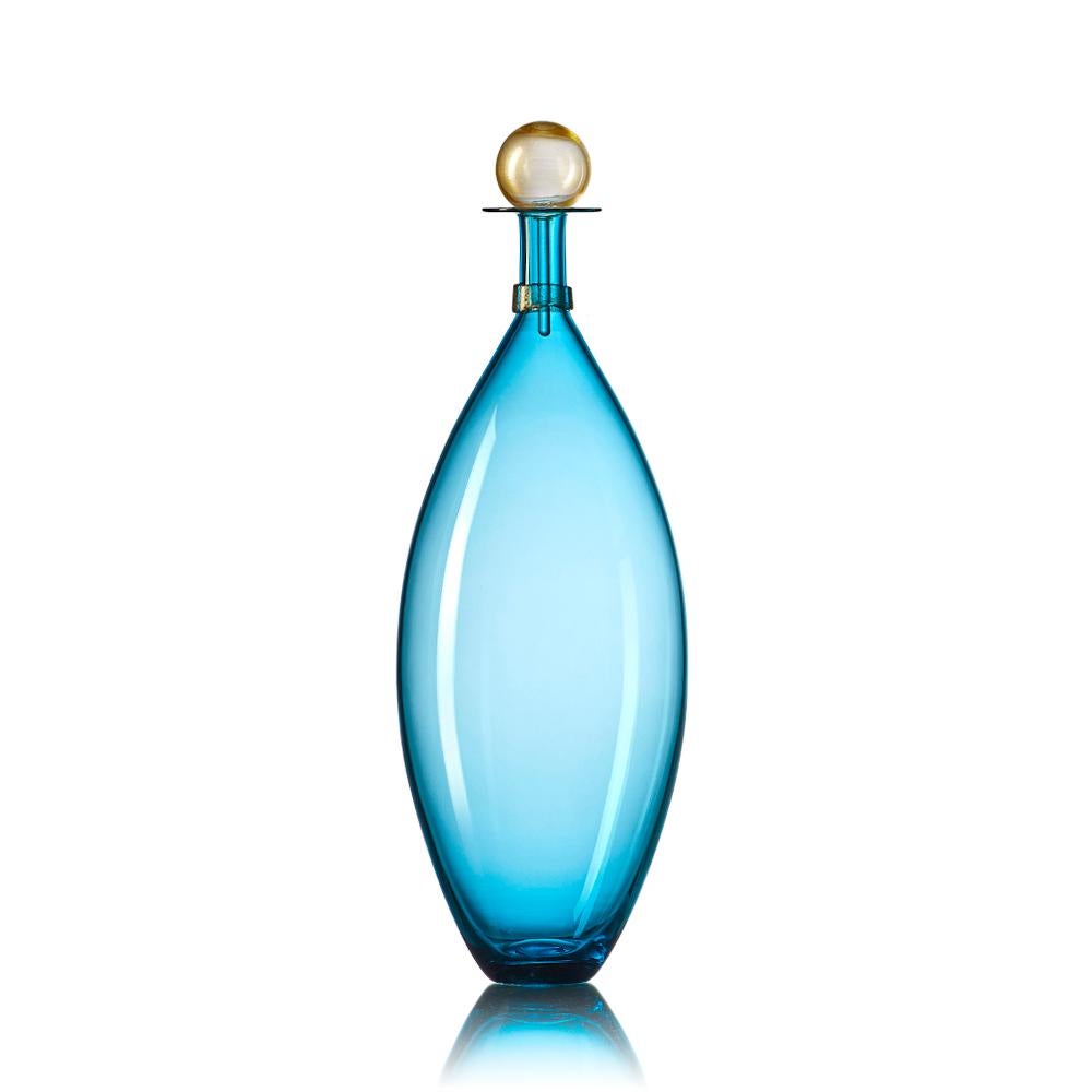 A vibrant set of three modern hand-blown glass bottles in a composition of geometric forms inspired by decanters of mid-century modern design. Coordinated neck-wraps and blown glass stoppers are finished with luminous gold-leaf details. Offered in a