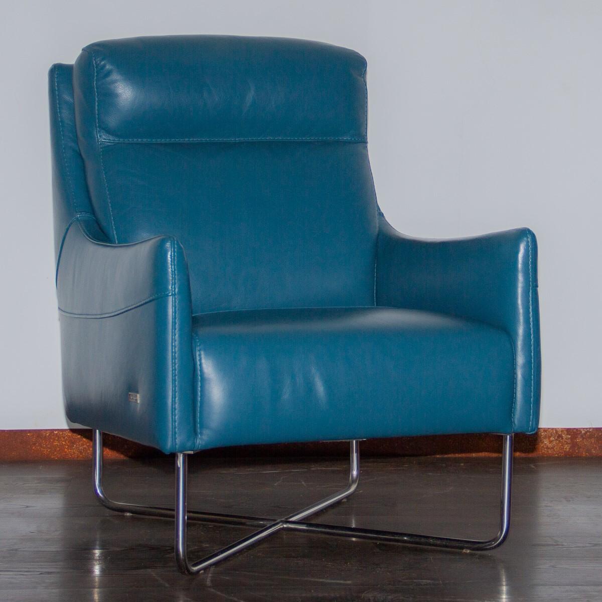 A 1990s vibrant blue leather armchair with down swept arms set on a chrome crossed frame by Violino. 

Excellent condition and very comfortable.