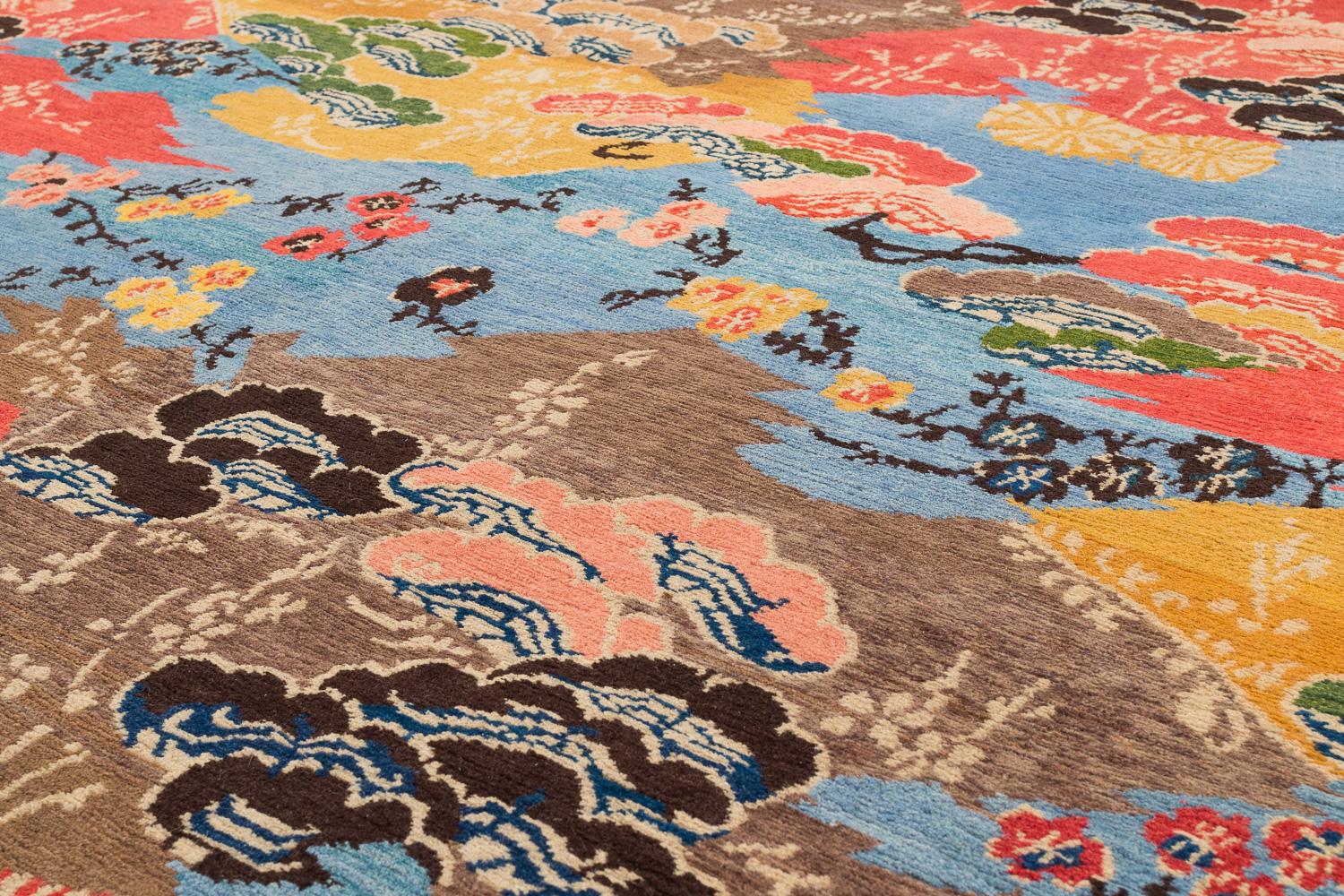Delicate flowers and Eastern motifs are scattered throughout Mountain Blossom's vibrant composition. The field of brilliant blue sets off the multicolored designs in this all wool carpet. Original design by Joseph Carini. Measures: 9’ x 12’.

This