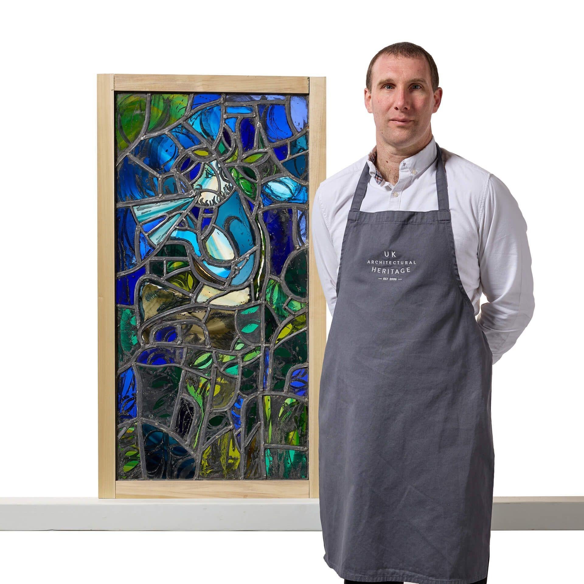 A unusual and wonderfully vibrant stained glass window with a mythical theme, signed ‘Wirth 75’.
 
This large abstract stained glass panel will make a unique feature window for any home. The artist cleverly uses stained glass in vibrant shades of