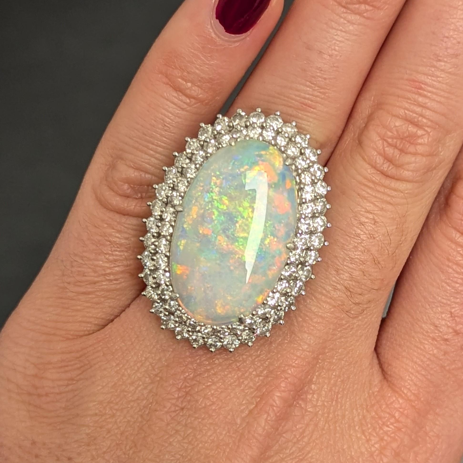 This ring features a powdery violetish blue-green Opal, surrounded by two rows of round diamonds, all set in platinum. 