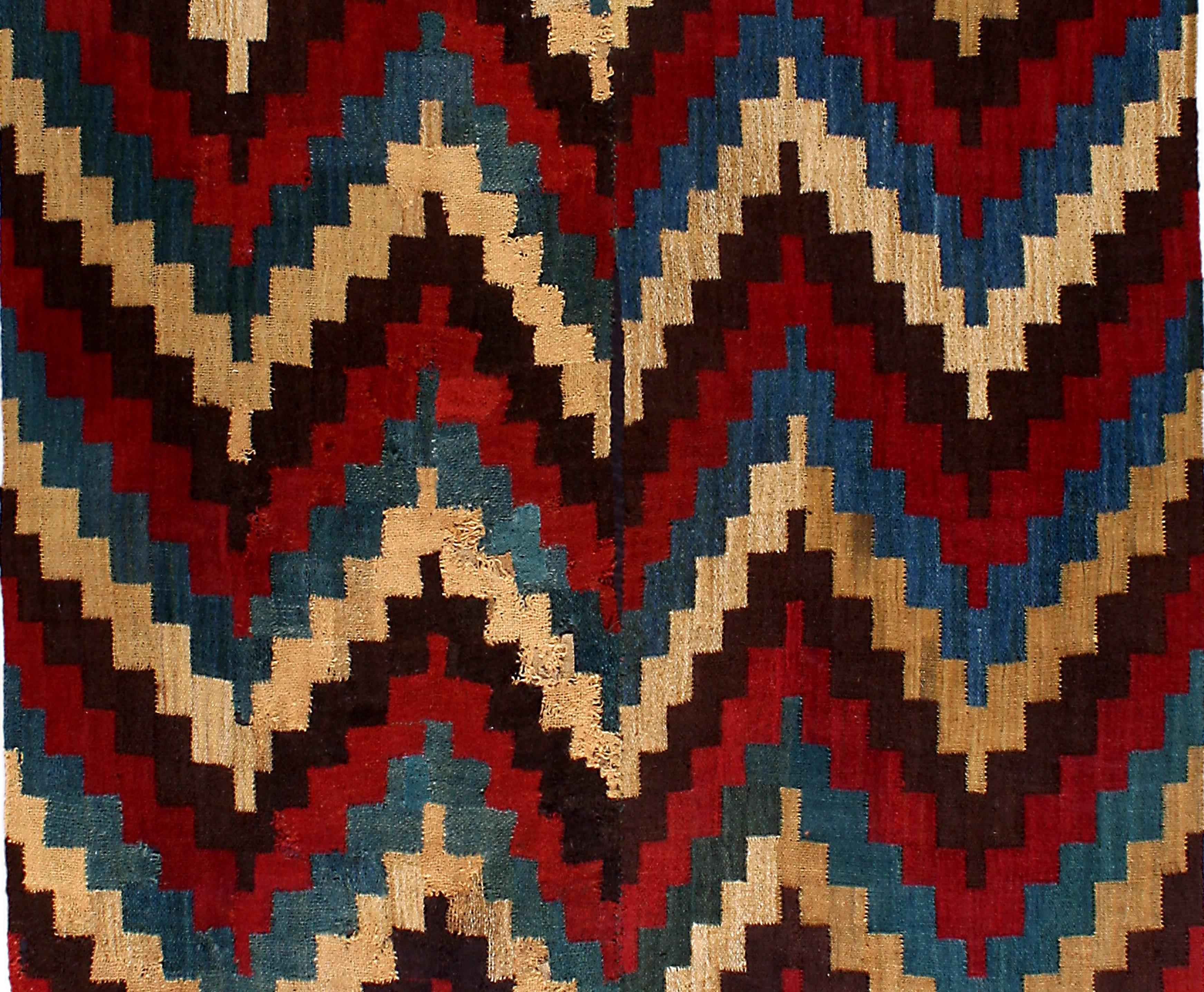 Magnificent Pre-Columbian Nazca Textile Poncho with a Geometric Step Design in Vibrant Ochre, Red, Green and Brown colors with its Original Fringes. Mounted and sealed in Plexiglass.

Provenance: From the Collection of Guillot Munoz

Additional