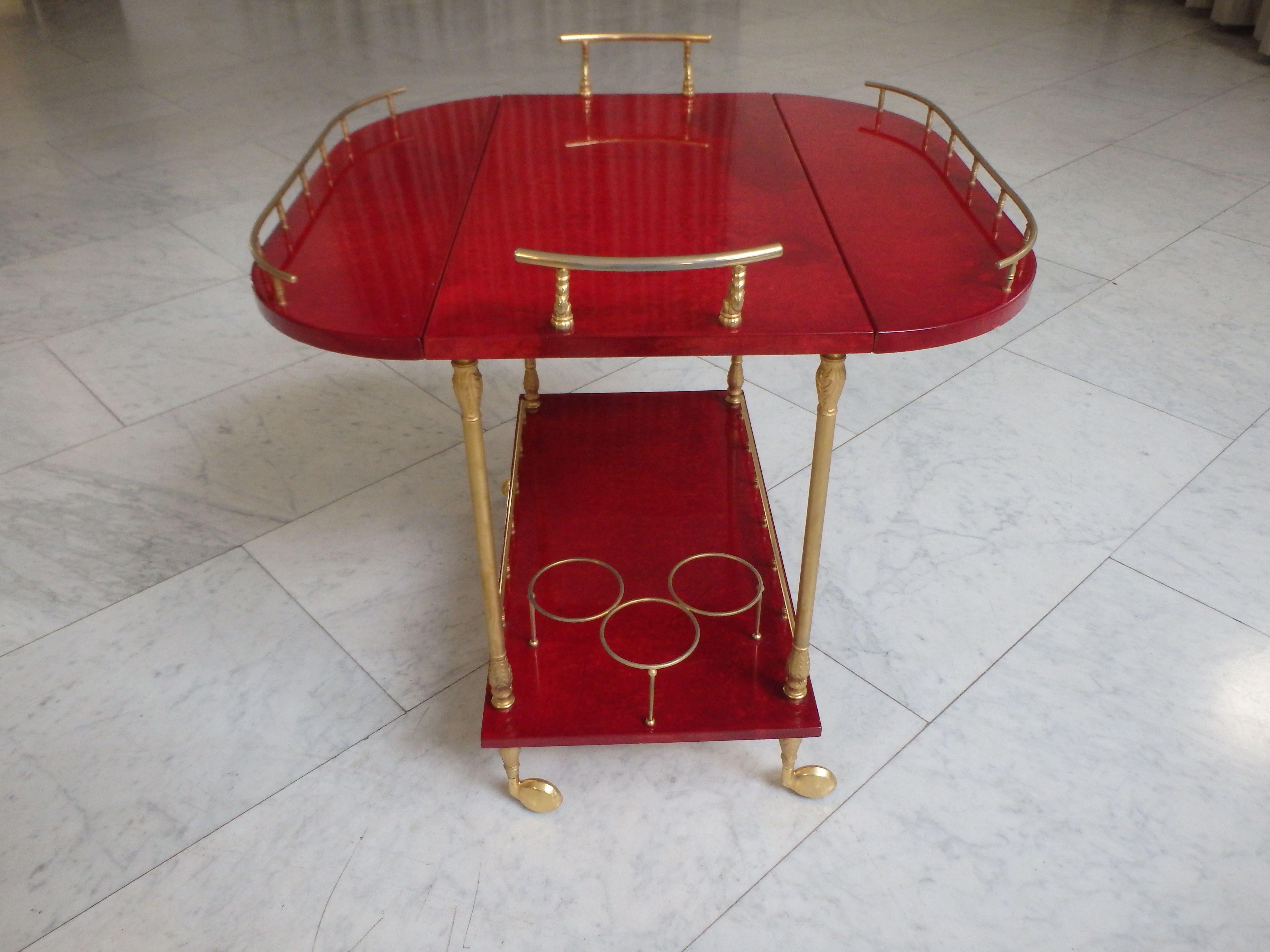 vibrant red coat skin bar cart by ALDO TURA with wings to be opened 
The size open is 78,5 x 75 cm.