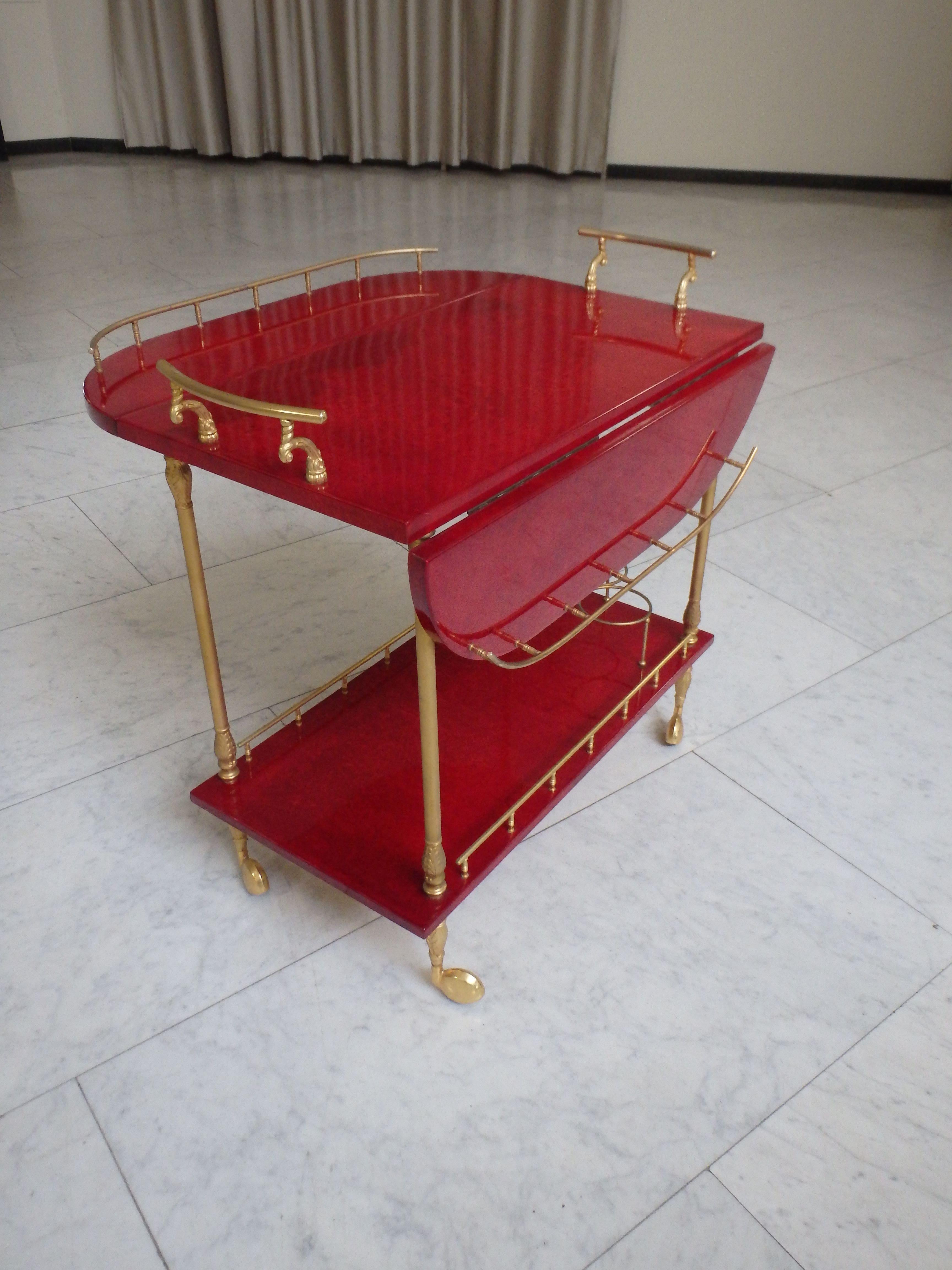 Brass vibrant red coat skin bar cart by ALDO TURA with wings to be opend For Sale