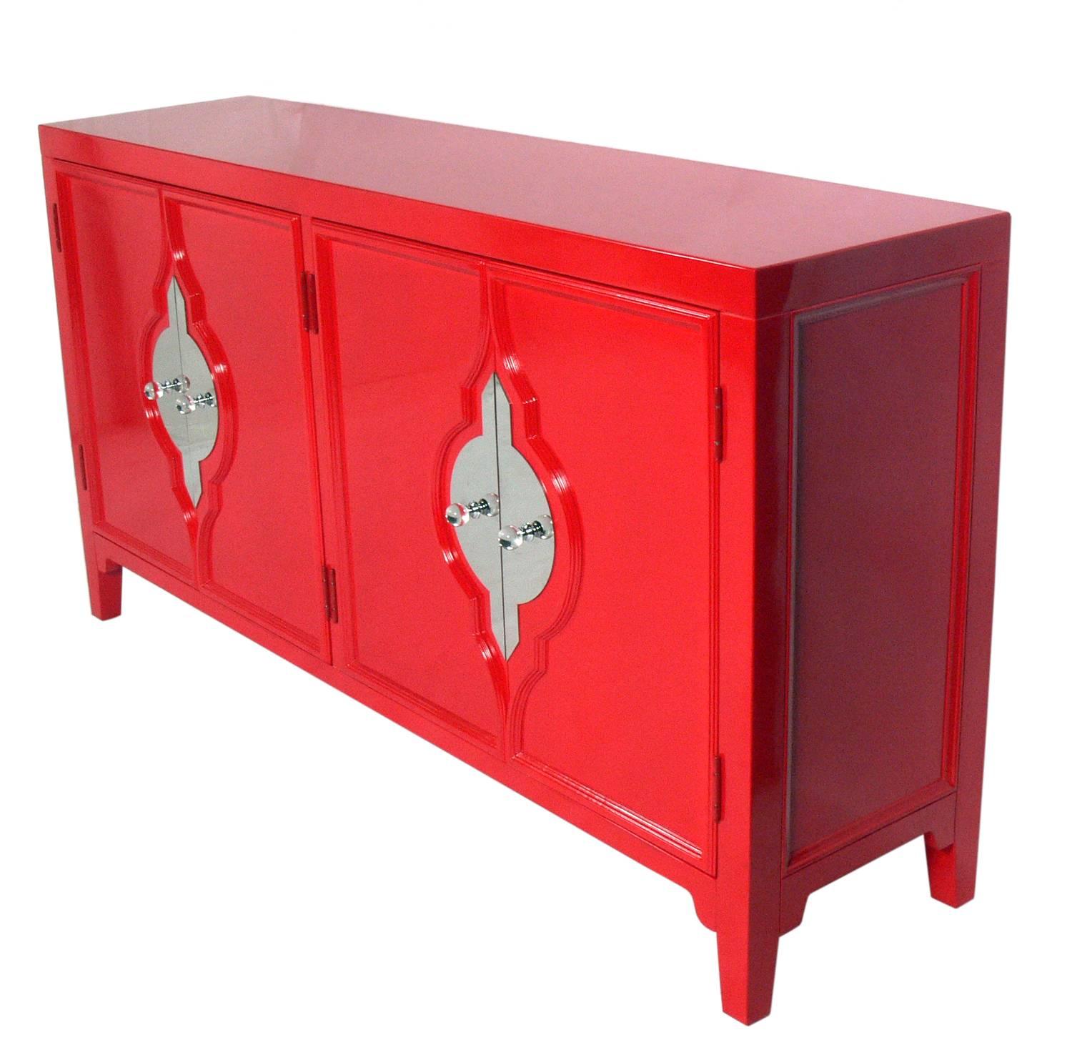 Vibrant red lacquer credenza, American, circa 2000s. This piece is a versatile size and can be used as a credenza, server, bar, or media cabinet in a living area, or as a chest or dresser in a bedroom. The double doors on either side open to reveal