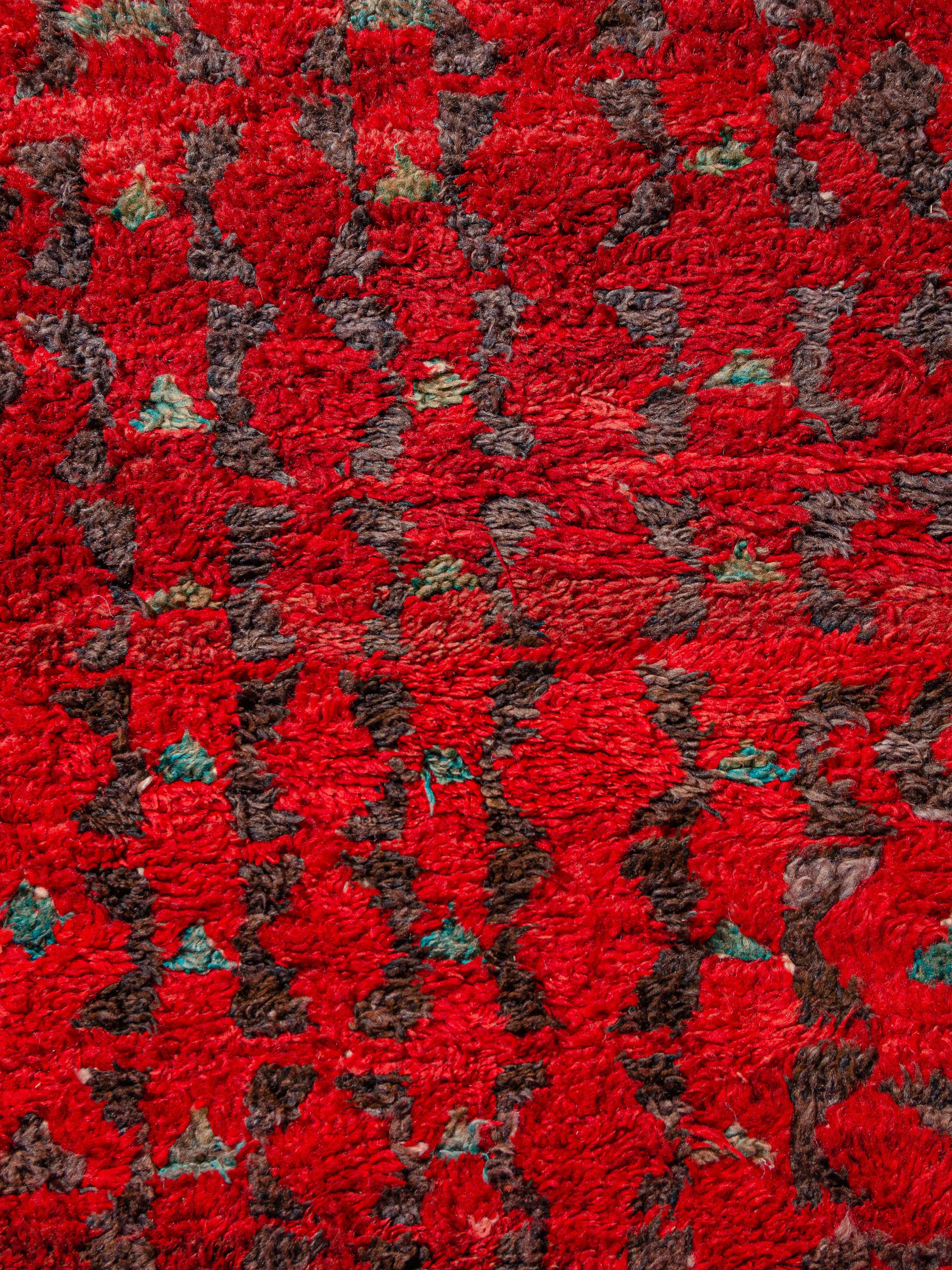 Incredibly vibrant Aït Bou Ichaouen (Talsint) vintage Moroccan carpet with linear symbols in charcoal and teal over an abrashed field of fiery red ground. The densely knotted pile has a subtle hand and a time-faded patina. Notice the interesting