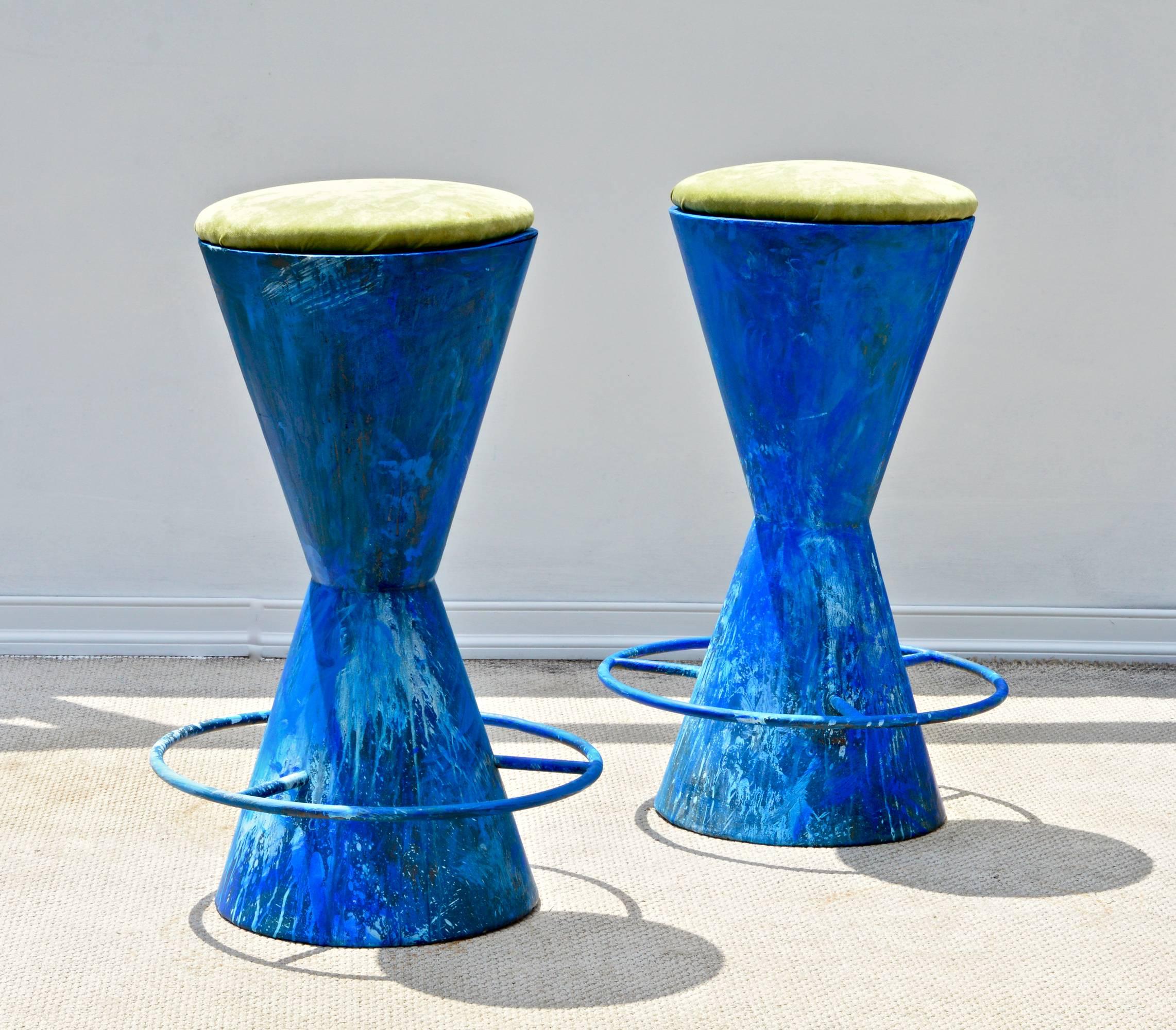 A unusual pair of Mid-Century Modern metal barstools from an art studio having chartreuse low pile velvet seats and whimsical hand-painted finish of very vibrant blue tones. The Industrial barstools are hand welded and seem to be one offs. A very