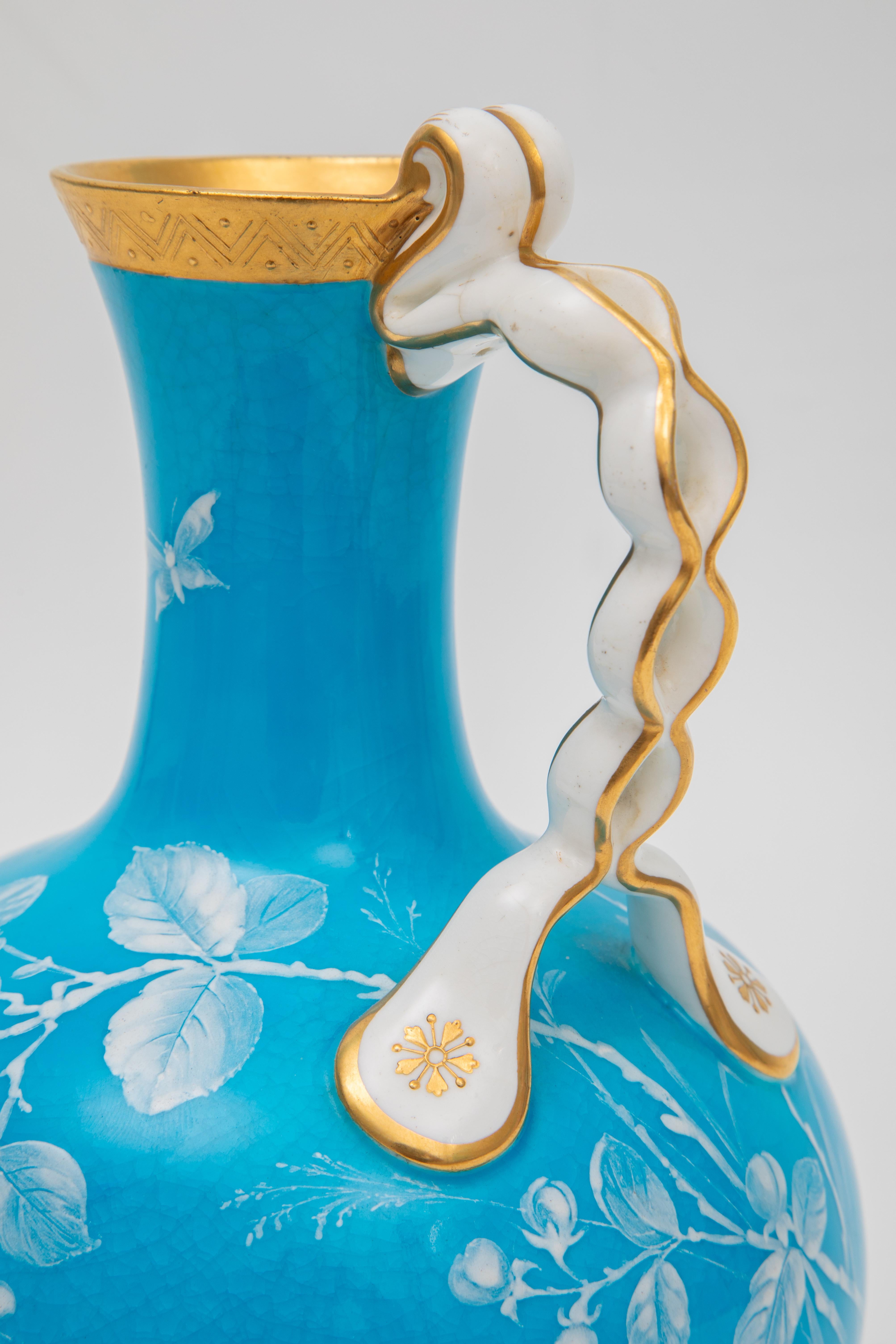 An aesthetically beautiful piece by one of our favorite Gilded Age companies, Minton England. Crafted in the 19th century and with great detailing to the raised white enamel decoration. We love the twist handle, the floral surround and butterfly