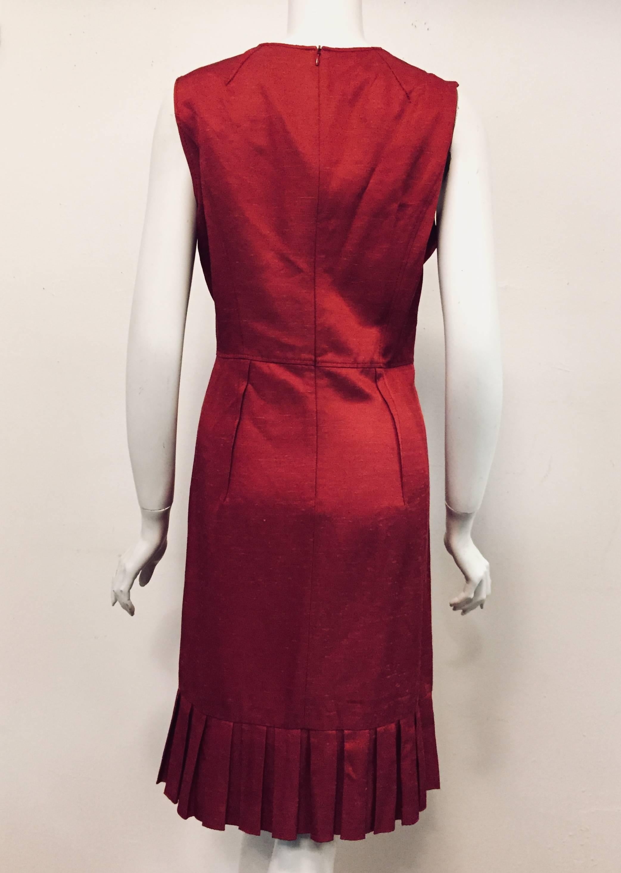 This Valentino very red wool blend dress is not lined, but for texture the dress has a great amount of top stitching around shoulders, waistline and darts at bust.  The hem of this dress is pleated all around adding to the Valentino look.  This