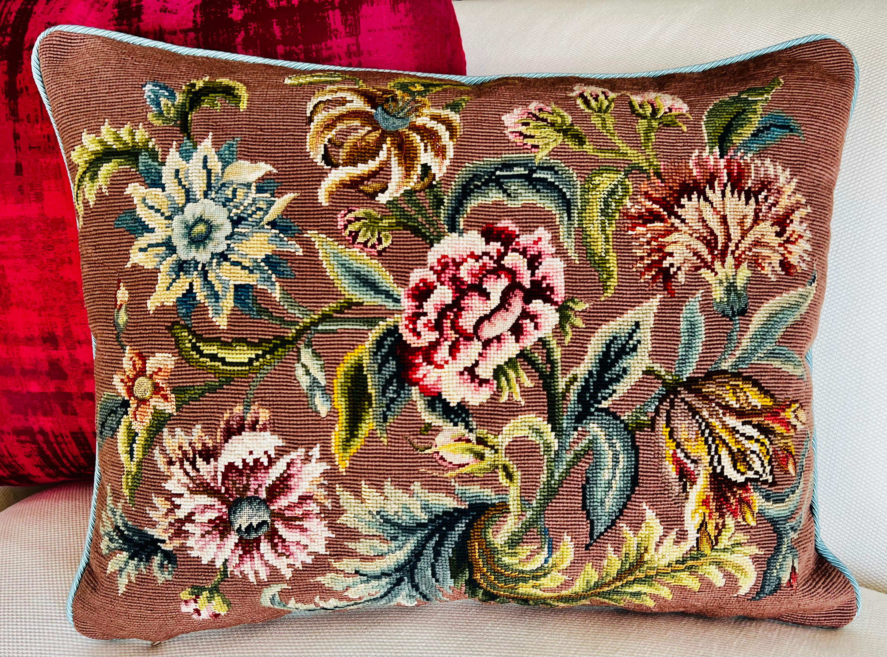Exceptional and vibrant vintage hand needlepointed pillow.  There are six large multicolored flowers with leaves on a cocoa colored ground.  The floral centers are petit point.  The old backing has been replaced with a horizontal ribbed fabric in a