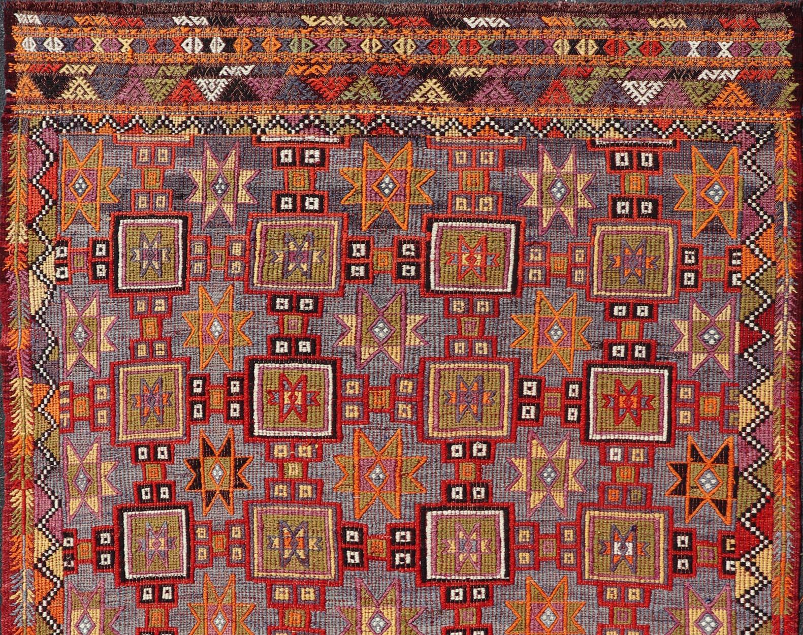 Measures: 6'5 x 9'0 
Keivan Woven Arts / rug/TU-NED-5084, country of origin / type: Turkey / Kilim, circa 1950. Vibrant Vintage Turkish Tribal Kilim Rug with Geometric Shapes. 
This vintage Turkish Kilim rug is a striking representation of