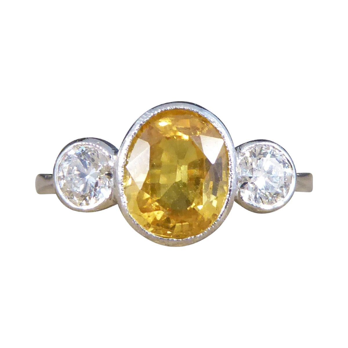 Vibrant Yellow Sapphire and Diamond Three Stone Ring in Platinum