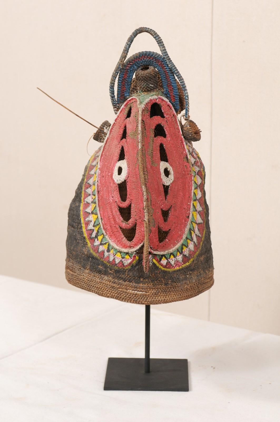 A Papua New Guinea yam festival mask, in the image of a horn-billed bird with vibrant coloring, from the mid-20th century. This vintage ceremonial mask, also referred to as a baba mask, originates from the Abelam people, along the East Sepik River