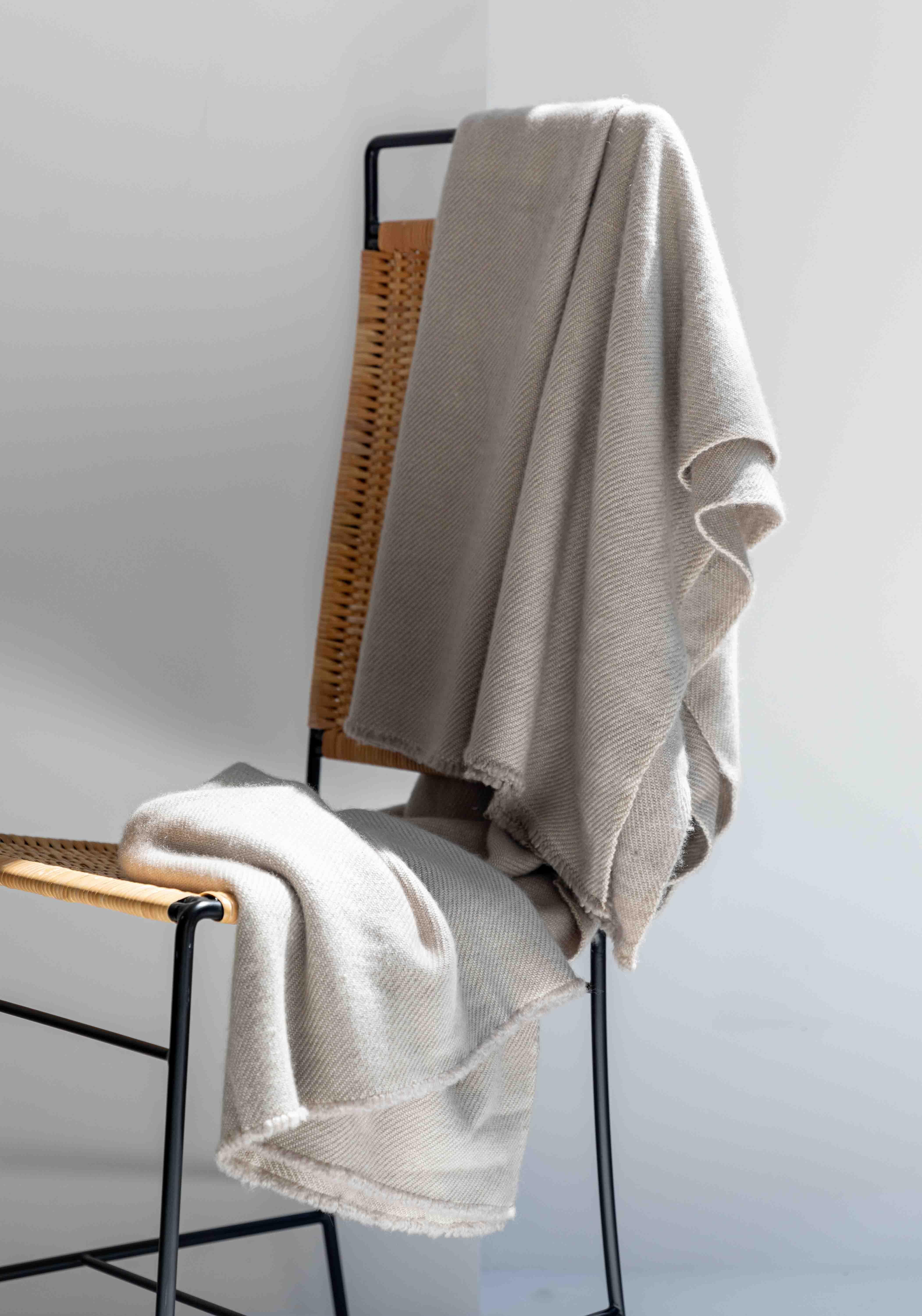 The Vica Cashmere Throw is handmade by artisans in Nepal using the finest cashmere and offered in four versatile colors meticulously created with 100% organic vegetable dye: green, cream, shahtoosh, and light grey. Available exclusively through