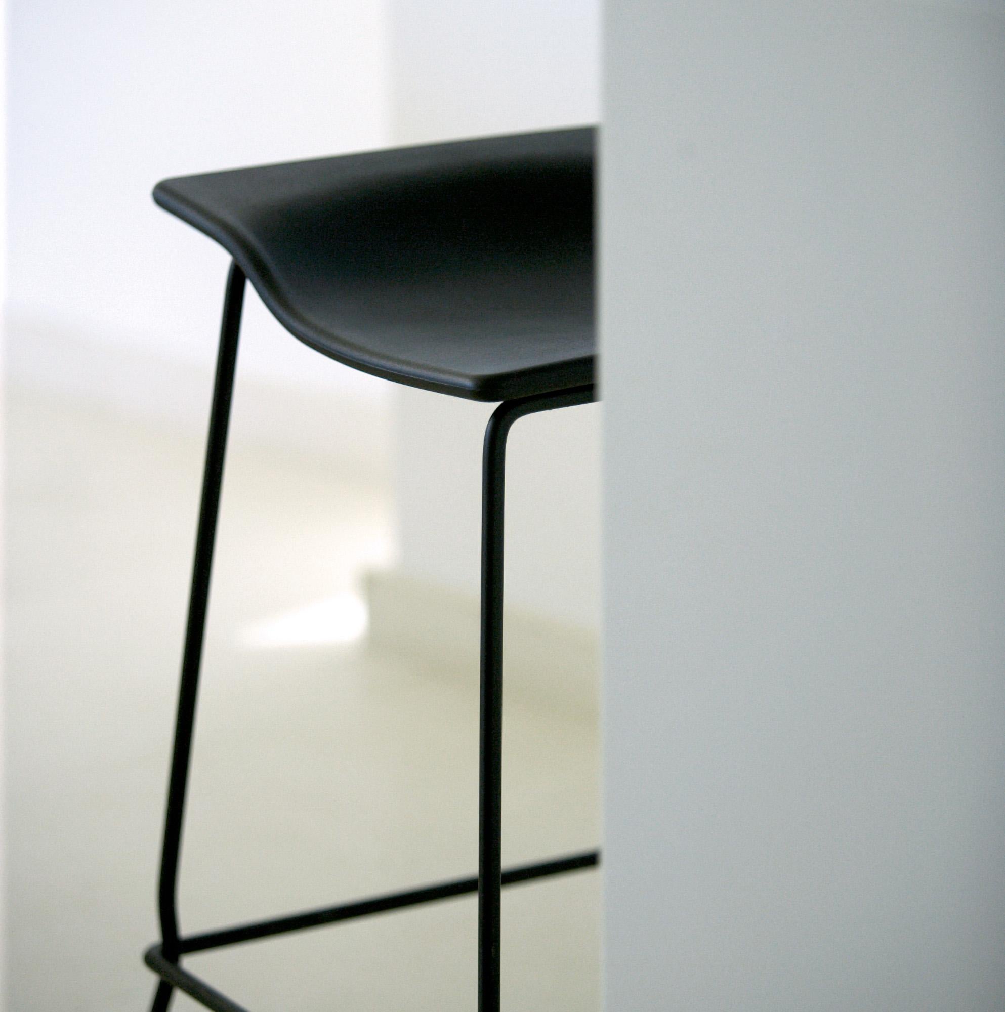 High stool by Spanish designer Patricia Urquiola for Viccarbe. 

A rotomoulded polyethylene seat with a lacquered steel frame and stainless steel footrest.

Its structural design has become a contemporary classic.

Its seat design makes it a very