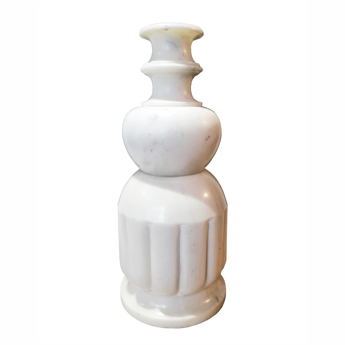 A tall marble vessel or vase, designed by renowned interior designer Vicente Wolf. 

This singular three-tier marble vessel is one of Wolf's signature home accessories. With its soft lines and smooth, sinuous body, this marble vase captures the