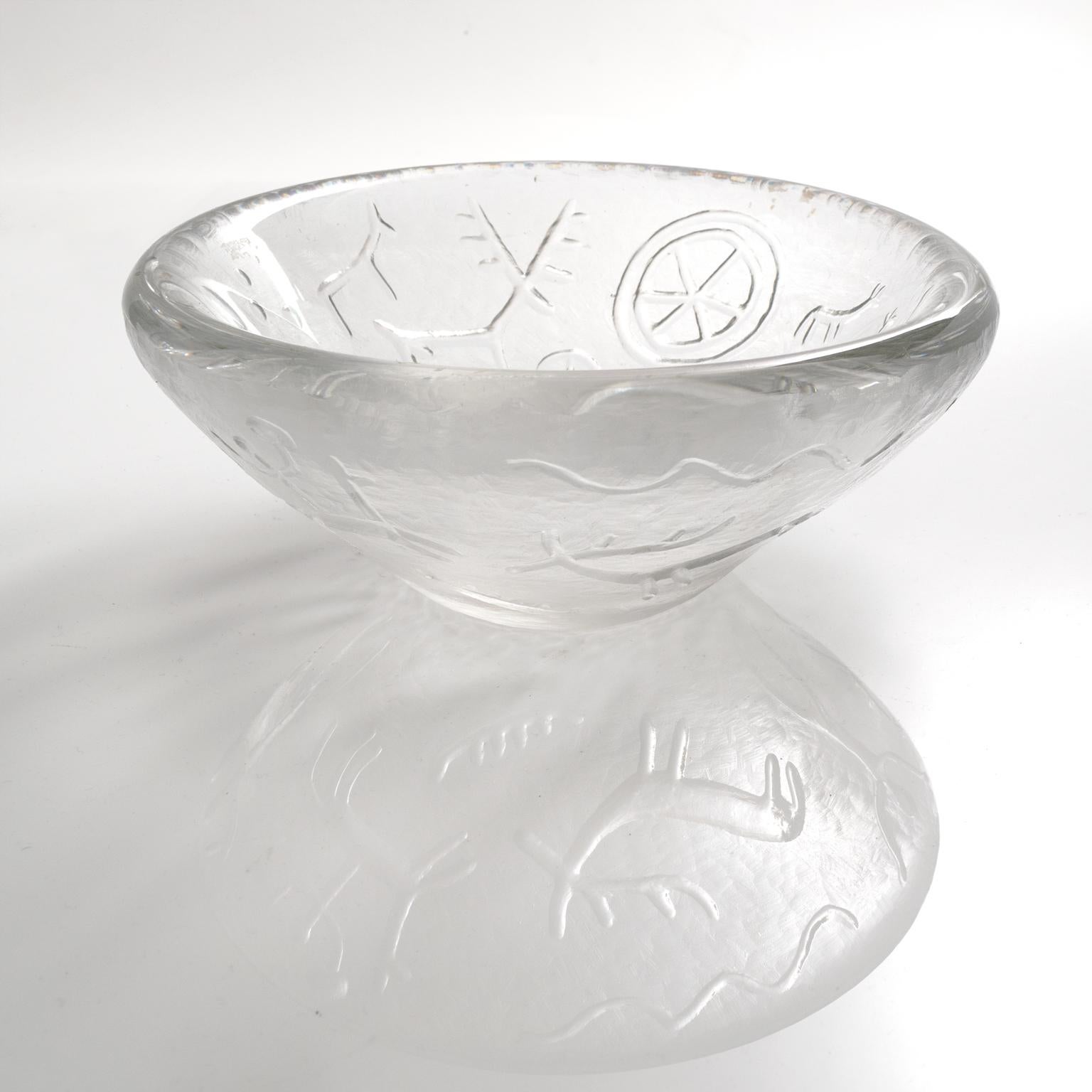 Swedish designer Vicke Lindrand designed this thick crystal bowl in the 1950s for Kosta. It depicts figures and symbols from pre-historic cave painting.

Measure: Diameter 9.5
