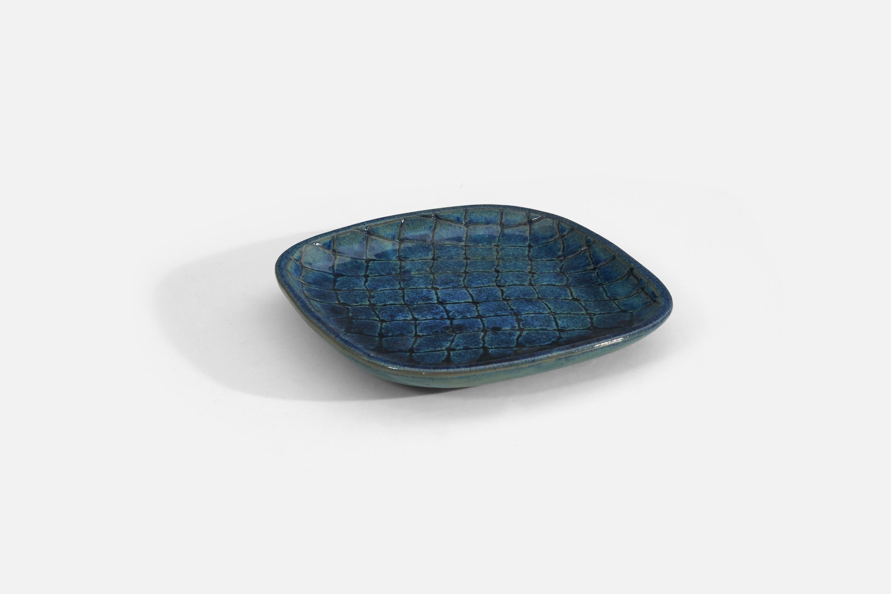 A blue-glazed earthenware dish or vide-poche designed by Vicke Lindstrand, for Upsala-Ekeby, Sweden, 1940s. 

