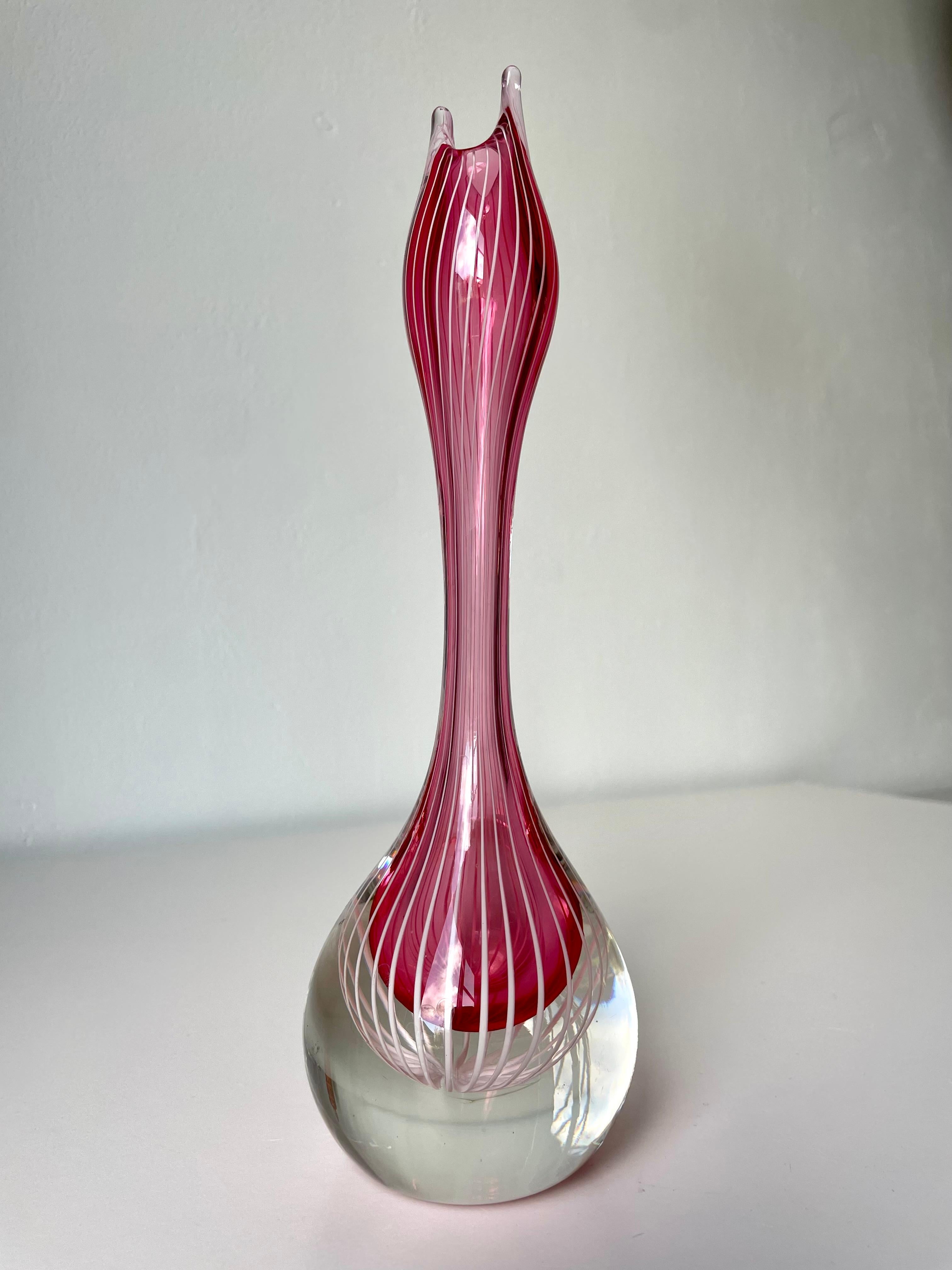 Elegant Swedish midcentury modern pink rose encased in clear art glass mouthblown Zebra vase with narrow white vertical lines. Flowing soft organic shape with clear round base, slender long body and tulip like asymmetrical opening. Designed and