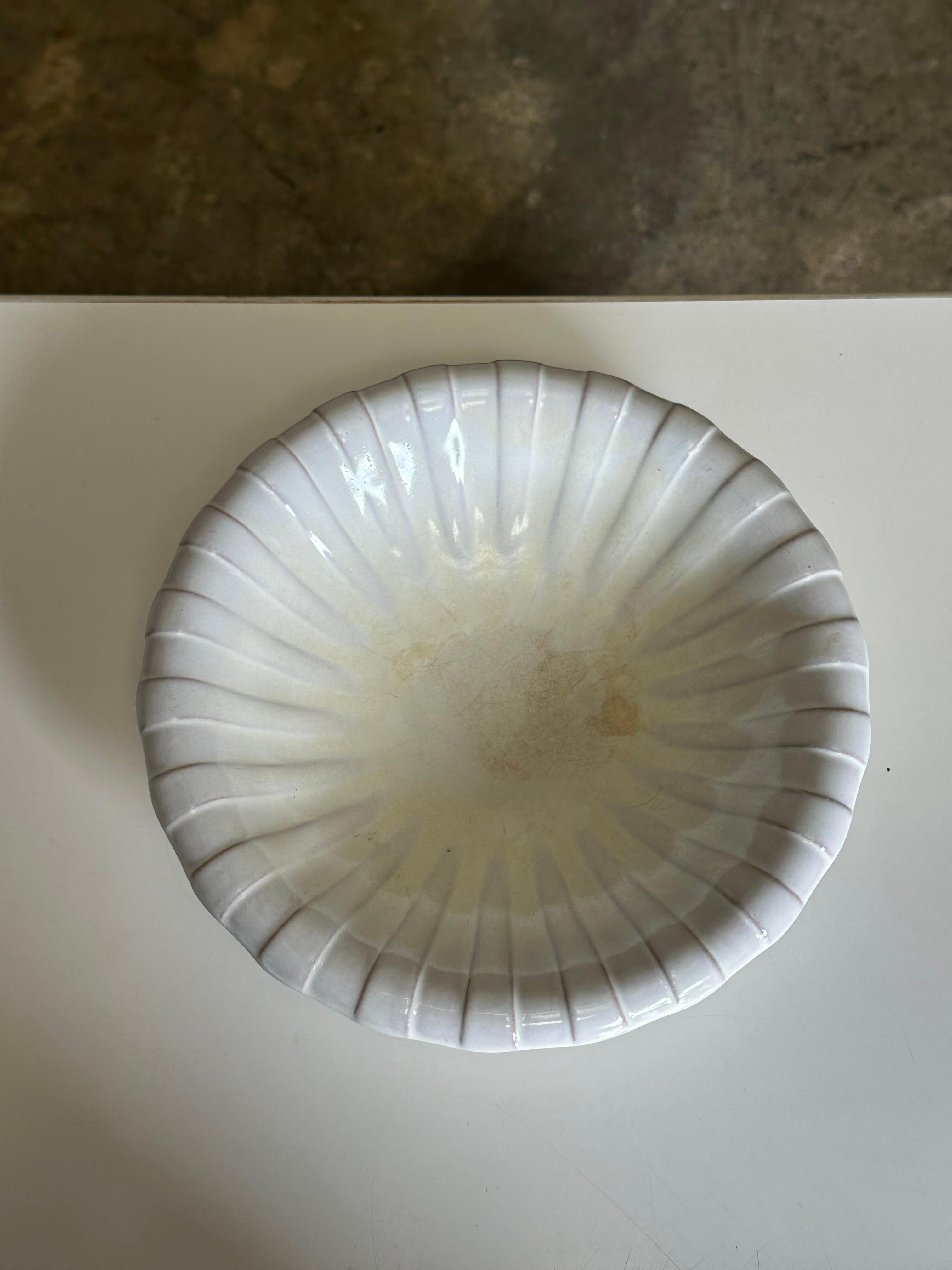A gorgeous large decorative bowl designed by Vicke Lindstrand for Upsala Ekeby. Features a almost shell like motif with alternating raised areas. Would work well as a fruit bowl. 