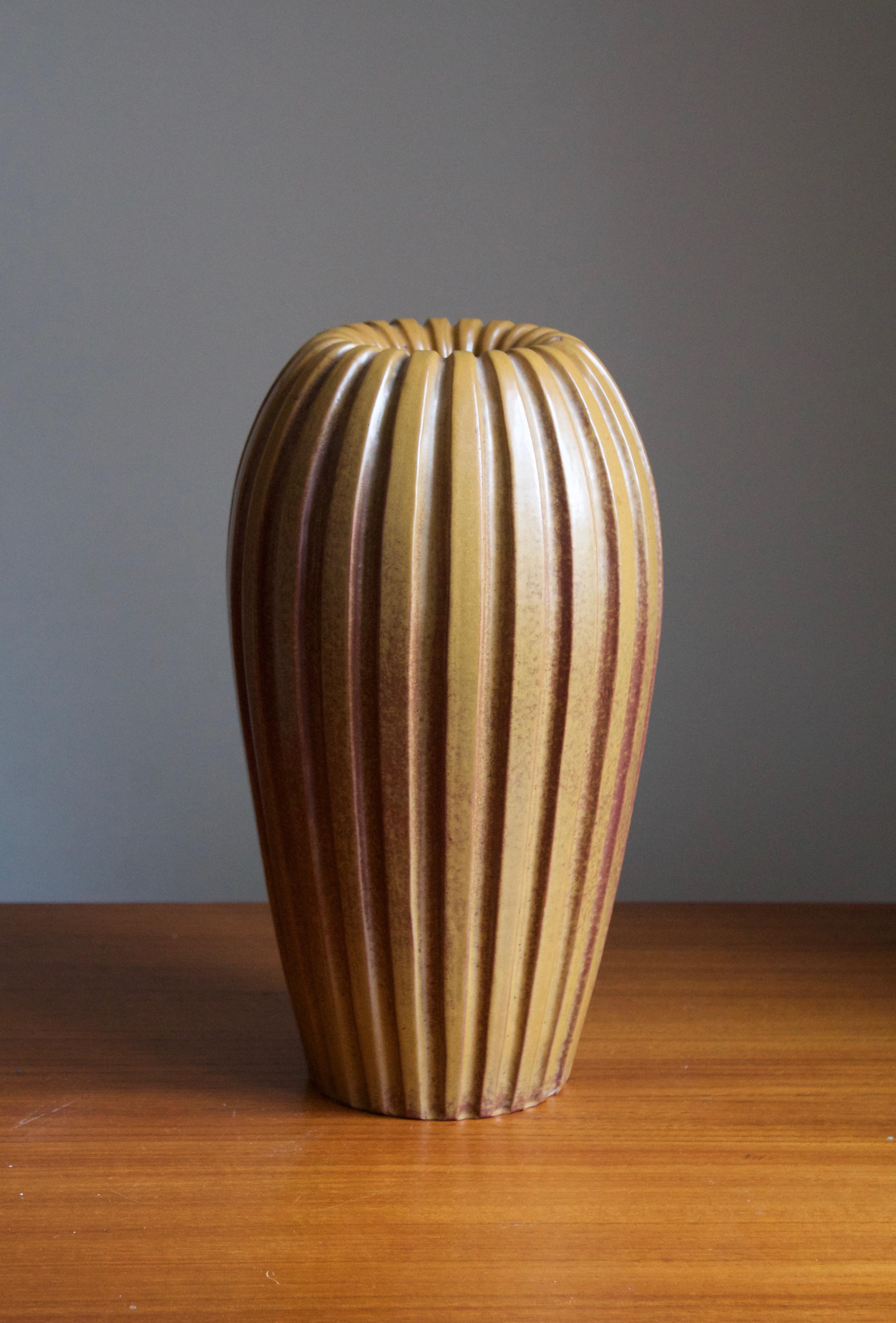 An early modernist vase. Designed by Vicke Lindstrand, for Upsala-Ekeby, Sweden, 1940s. Rare version with beige / brown glaze.

Other designers of the period include Ettore Sottsass, Carl Harry Stålhane, Lisa Larsson, Axel Salto, and Arne Bang.