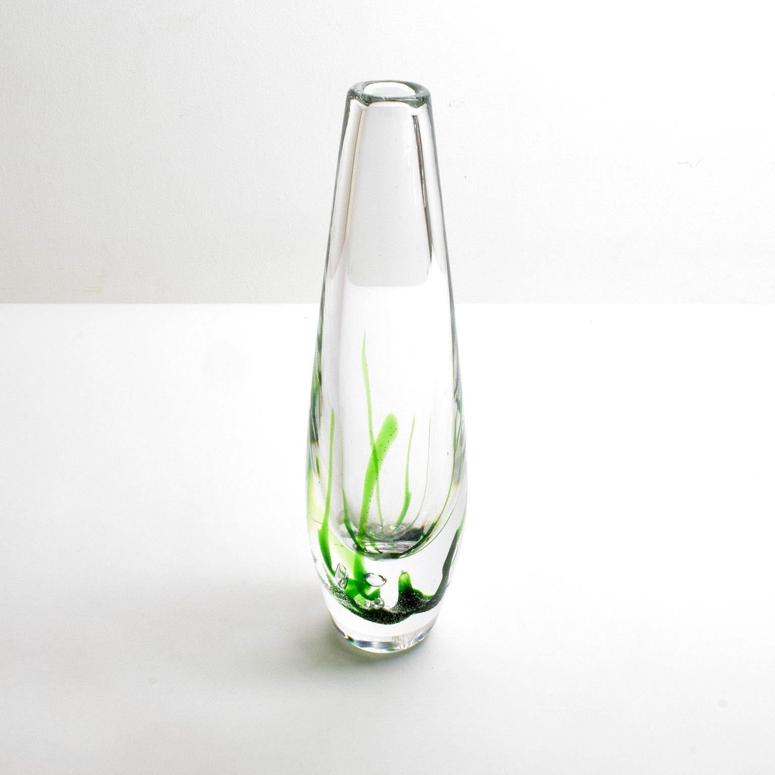 Vicke Lindstrand clear glass vase with green streaks from his “Seaweed Series” for Kosta Glassworks, Sweden, 1960. 

Vicke Lindstrand was a master of form and applied decoration. His glass and ceramic works during his career reflect his