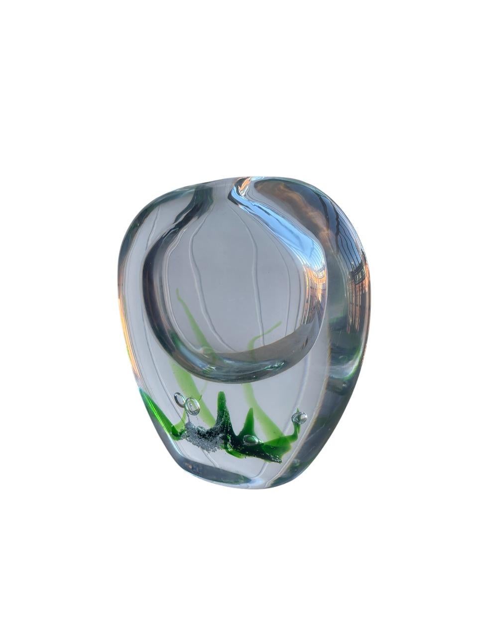 Elegant hand-blown glass vase from the sought-after “Seaweed” series, designed by legendary Swedish glass artist Vicke Lindstrand for Kosta Glasbruk. Each vase in this series is a unique work of art, featuring vivid green “seaweed” tendrils and