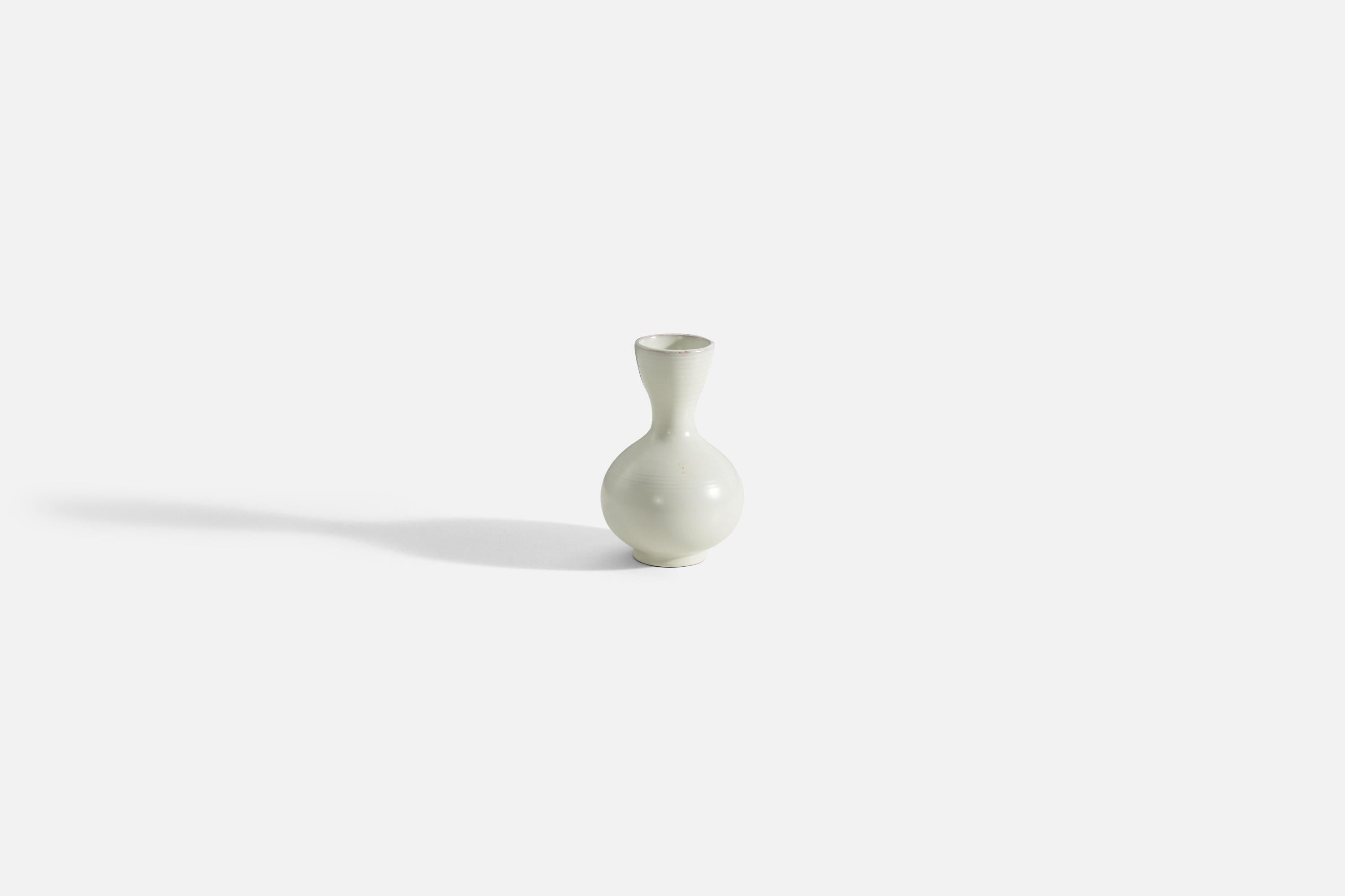 A white-glazed earthenware vase designed by Vicke Lindstrand, for Upsala-Ekeby, Sweden, 1940s. 

.