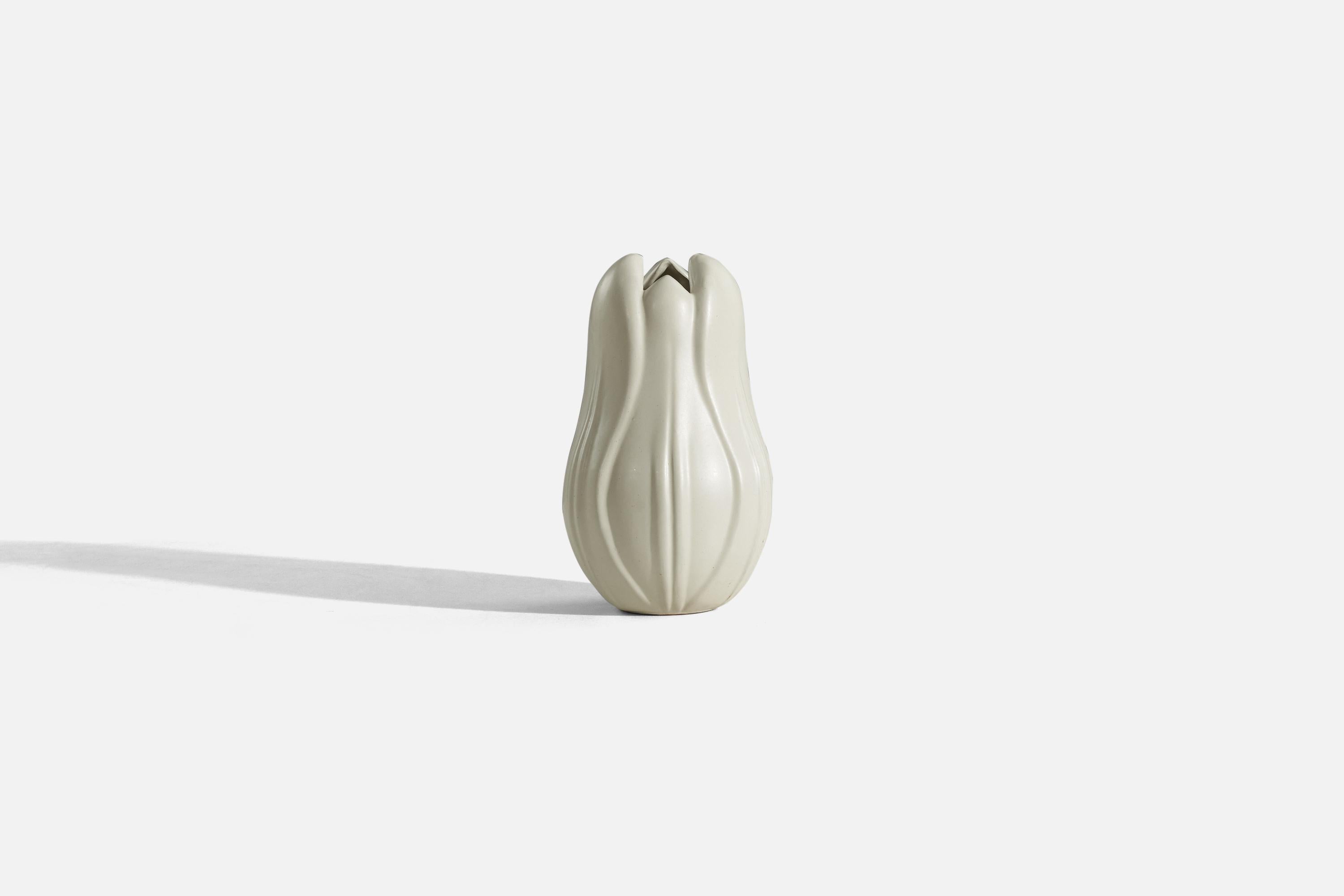 A white-glazed earthenware vase designed by Vicke Lindstrand and produced by Upsala-Ekeby, Sweden, 1940s. 


