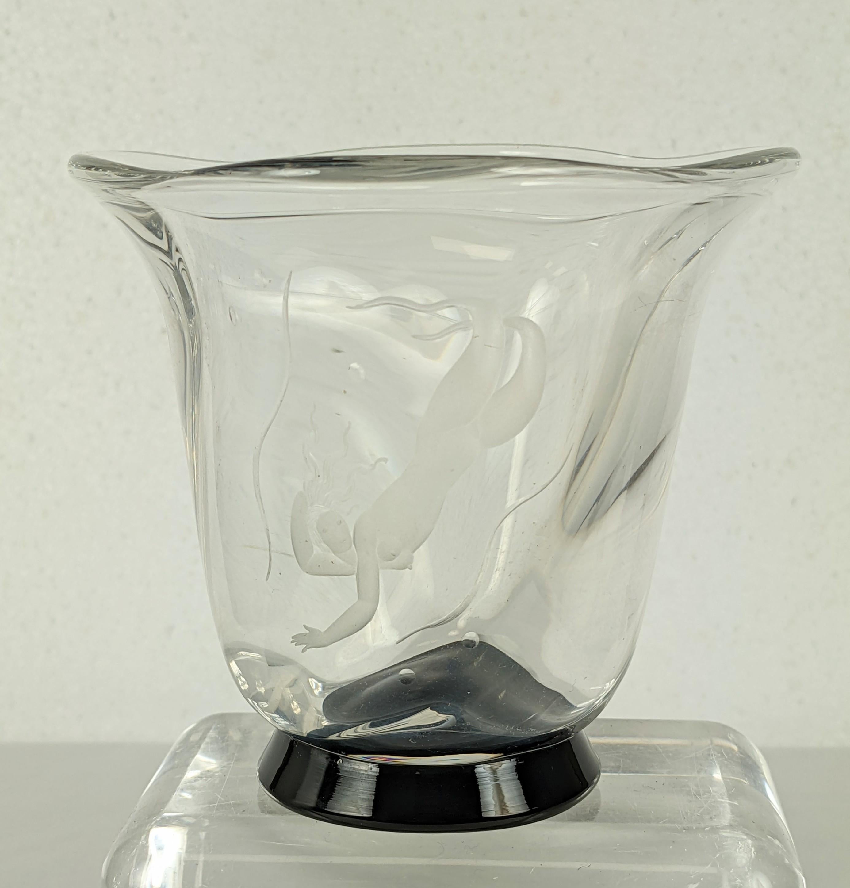 A lovely and charming example of Vicke Lindstrand's elegant, stylized figures on glass, made for the Orrefors glass company in Sweden. This Art Deco vase features an engraved mermaid diving downward into the bubbles. 
The thick glass vase is gently
