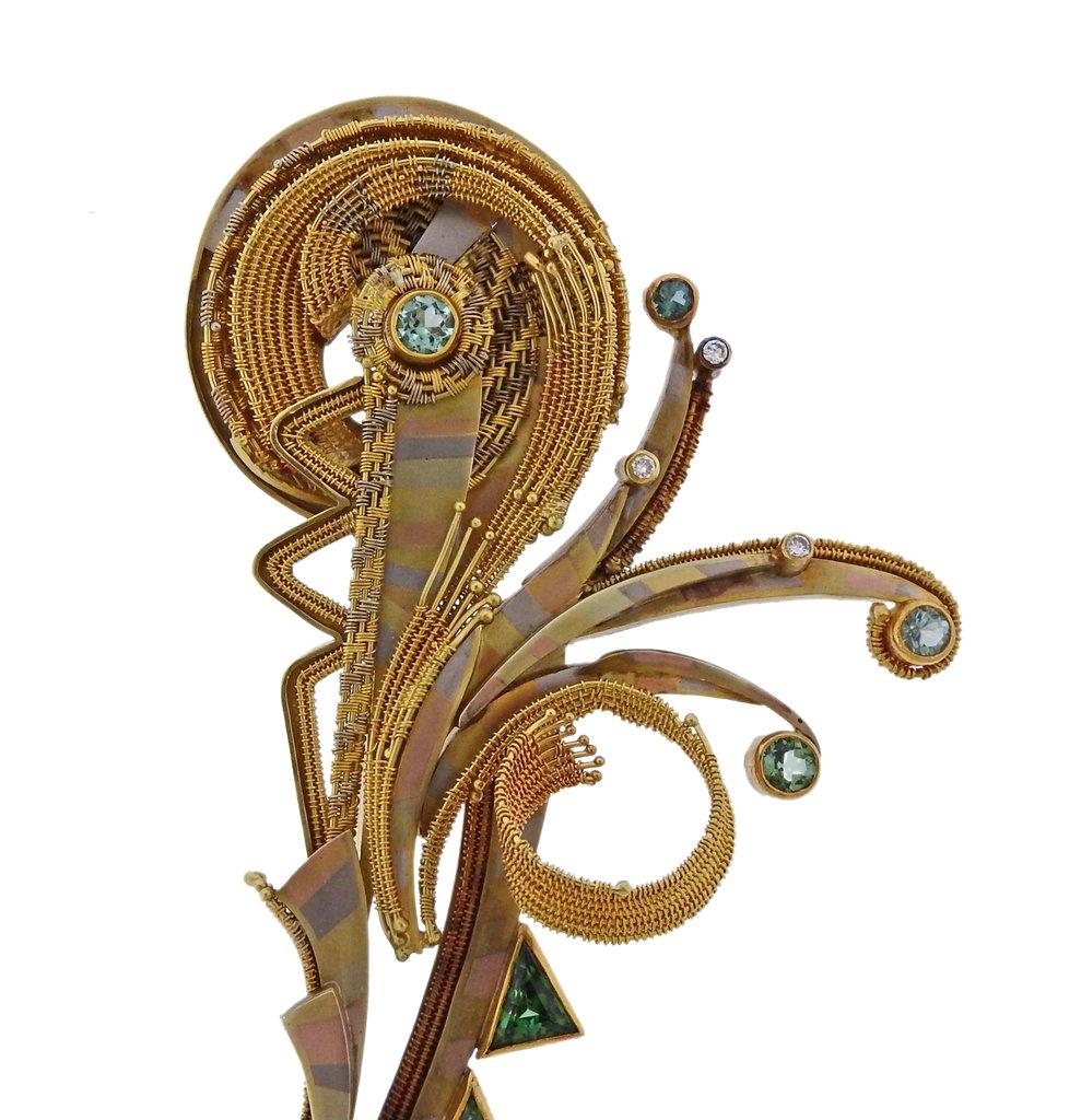 Large unusual brooch, crafted by Vicky Eisenfeld, set in 14k 18k and 22k gold, approx. 0.06ctw in G/VS diamonds, bright blue and green gemstones.  Brooch is 133mm x 58mm. Marked -  V. Elsenfeld signature, 14k 18k 22k. Weight - 74.5 grams. The work