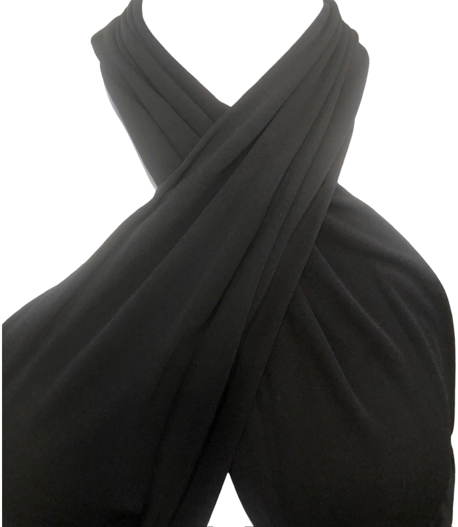 This is the dress version of a Jackie Collins novel circa mid 1980s by Vicky Tiel. Black jersey in a sinuously shirred body con silhouette, Cross cross halter neckline with peekaboo middle section and cut out back. Fully boned bodice and tightly