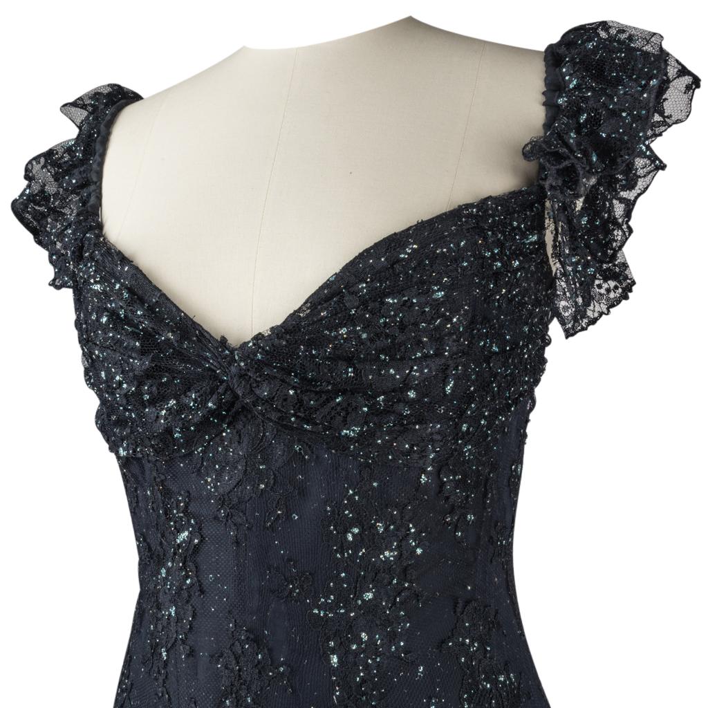 Guaranteed authentic Vicky Tiel Couture deep navy trumpet mermaid gown with blue diamante encrusted netting and lace overlay.
Sweetheart neckline with elasticized frilled shoulder straps.
Beautifully detailed netting with lace and varying size