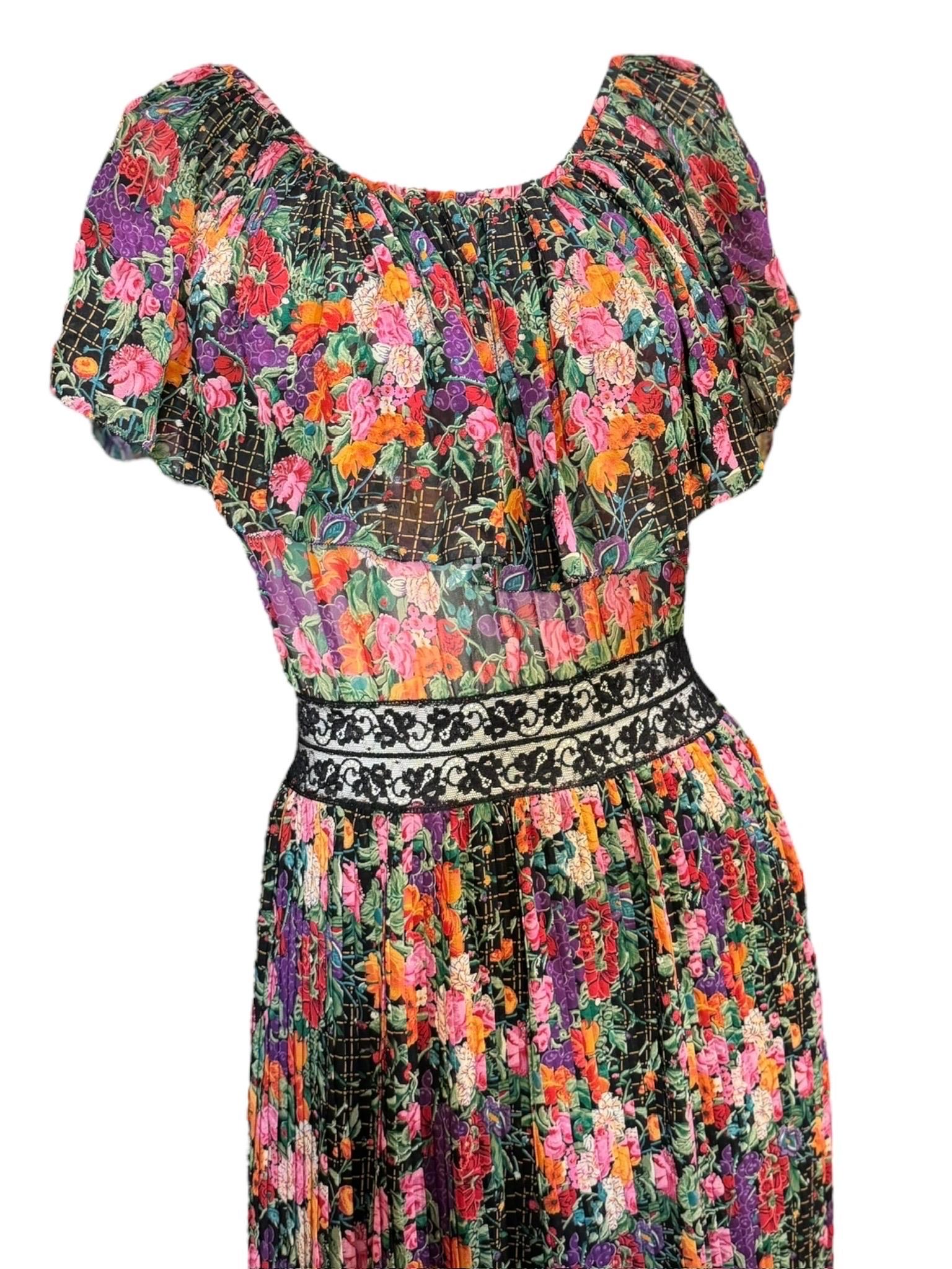 A rare and likely one-of-a-kind couture piece by Vicky Tiel, this 1970s gown is a romantic masterwork in sheer floral silk chiffon. Designed with a ruched, off-the-shoulder neckline and flutter sleeves, the silhouette evokes bohemian elegance with a
