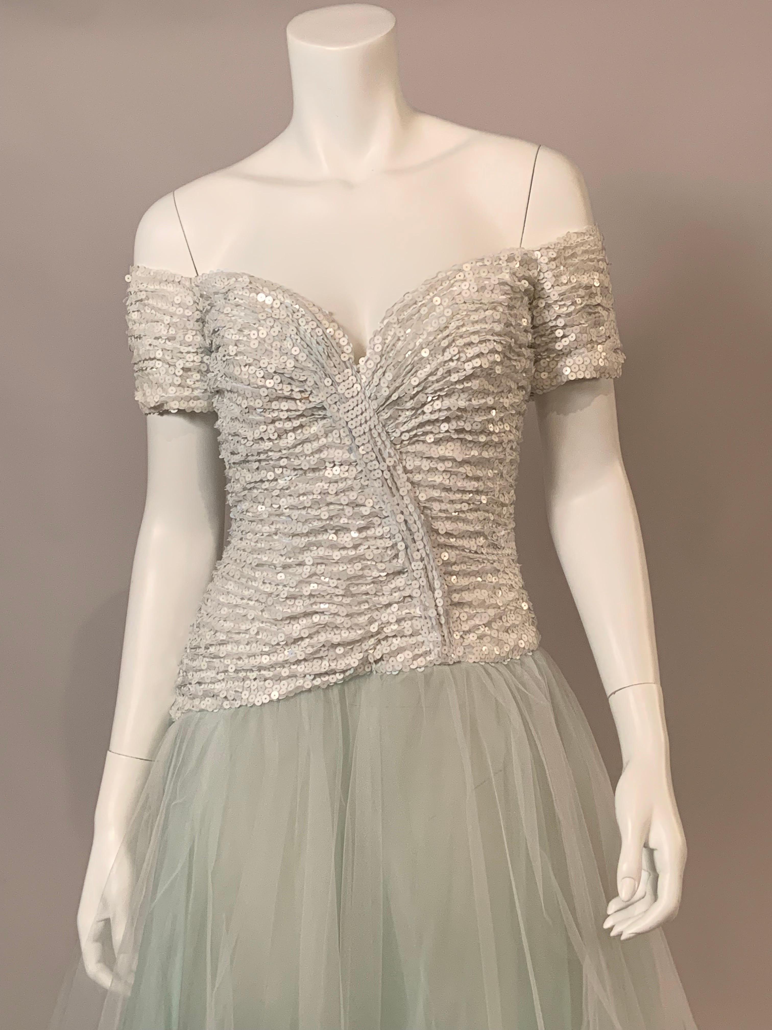 This dress is so romantic, it would be perfect for a wedding or a special formal event.  The off the shoulder bodice is gathered white chiffon covered with bright white sequins in a faux wrap style.  But the skirt!  This is made from four sheer